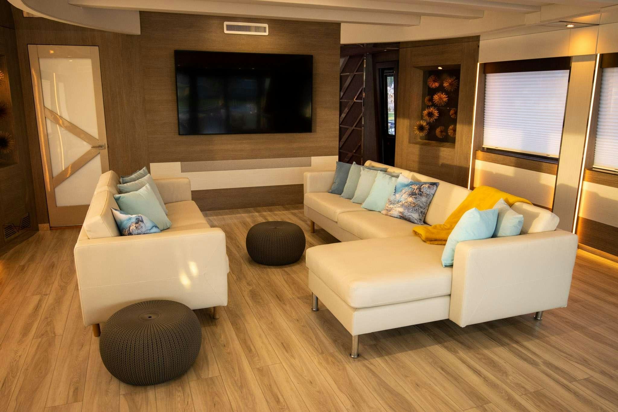 a living room with a couch and a television aboard JULIANNE Yacht for Charter