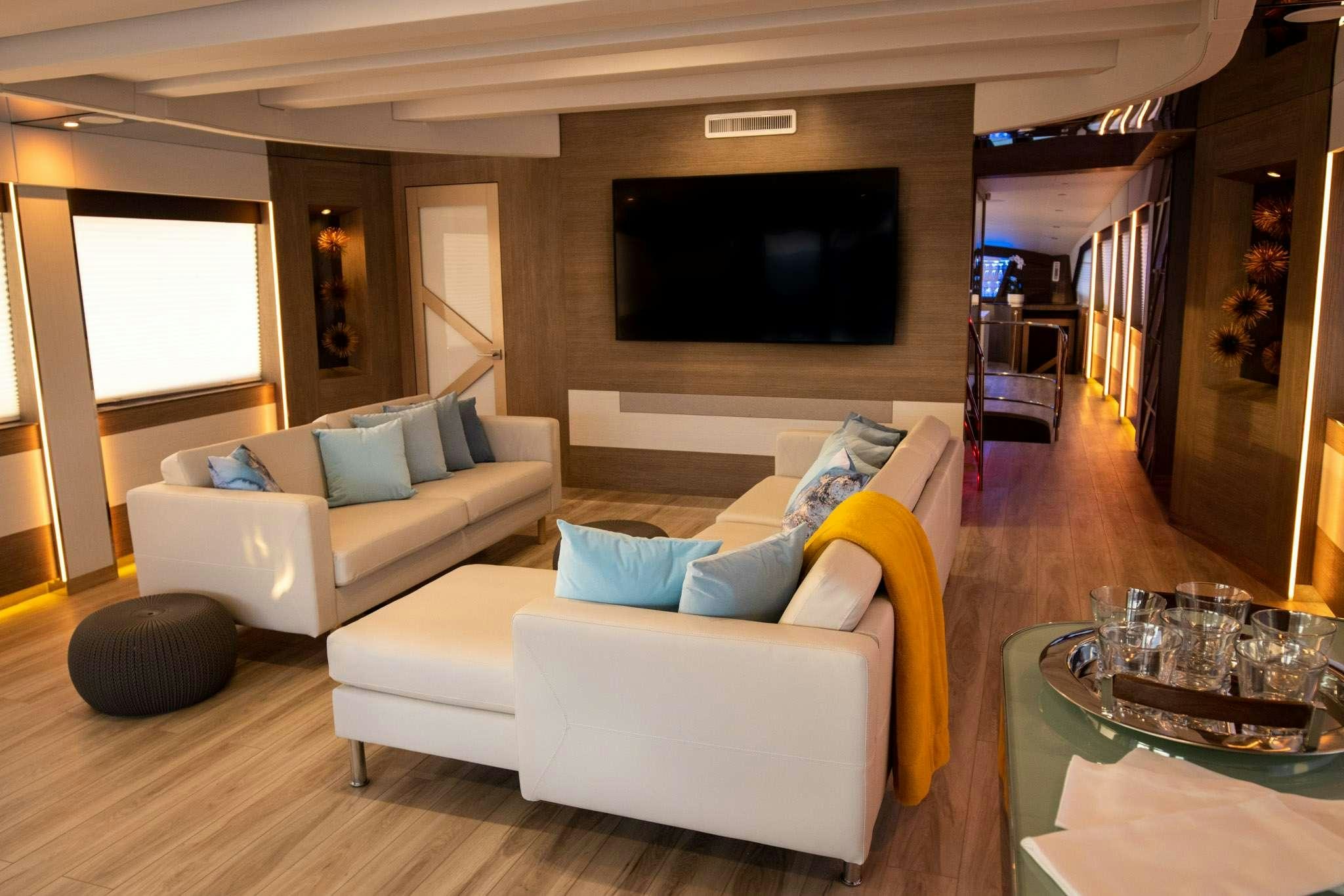 a living room with a couch and a tv aboard JULIANNE Yacht for Charter