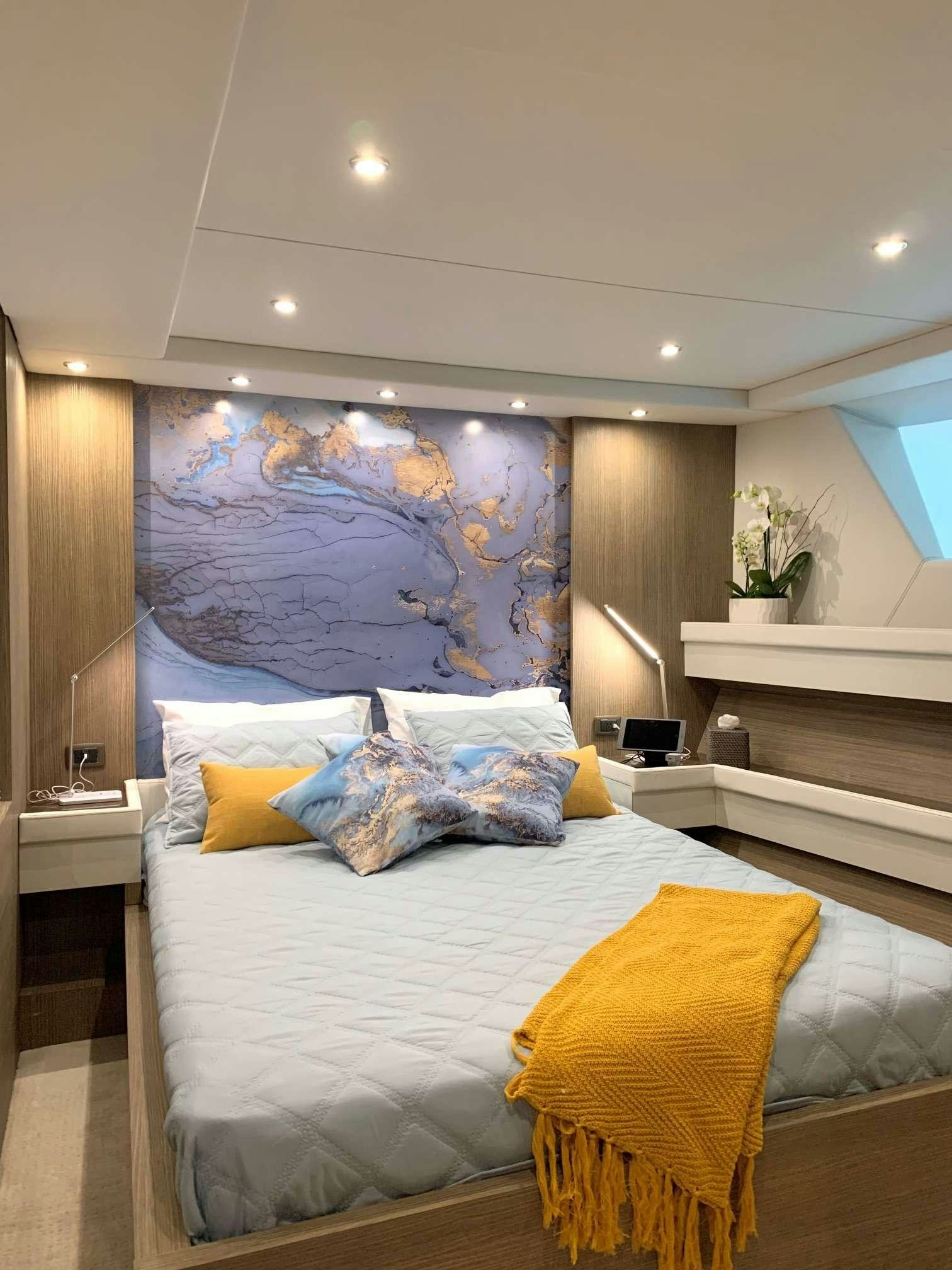 a bed with a white bed spread aboard JULIANNE Yacht for Charter