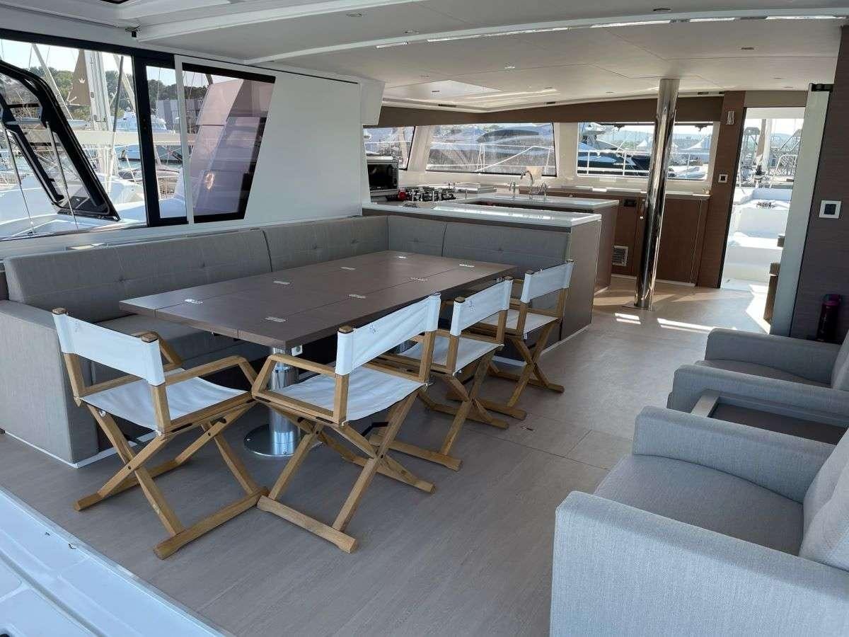 a room with a table and chairs aboard SIMONE V Yacht for Charter