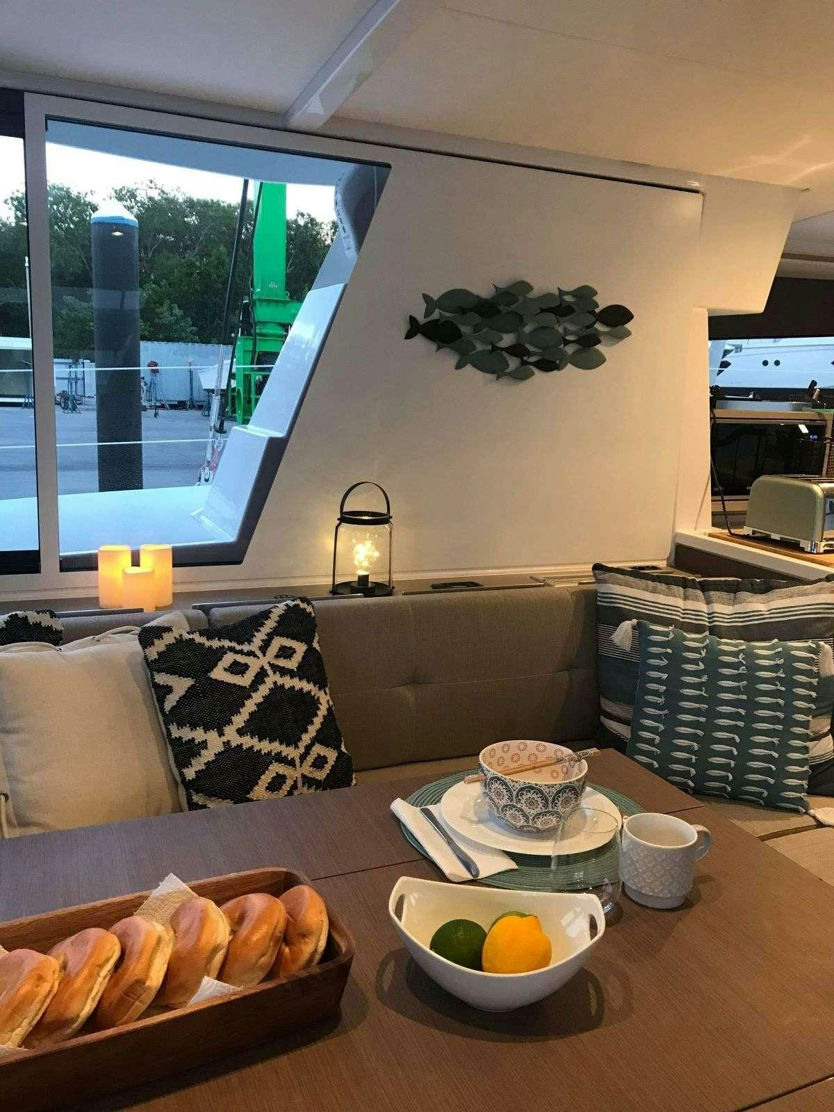 a table with food and drinks aboard SIMONE V Yacht for Charter