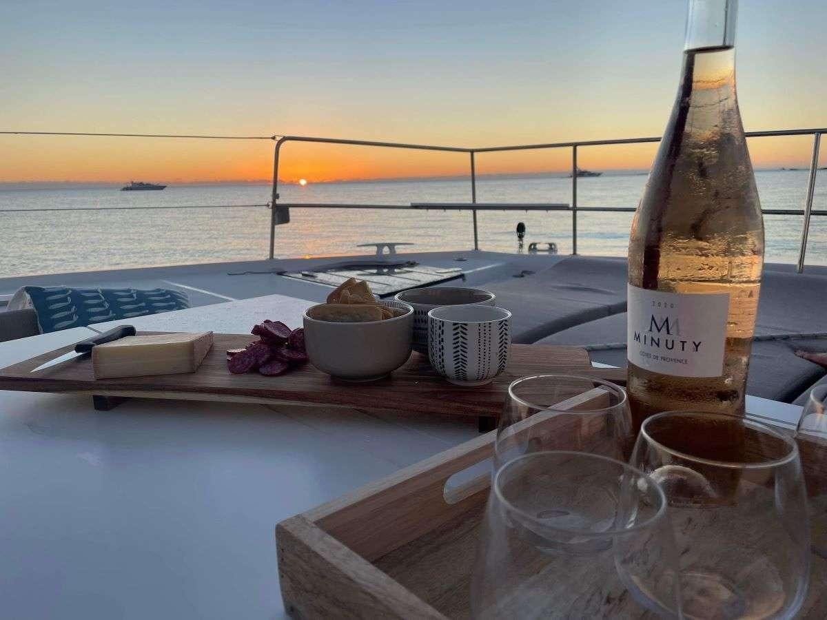 a bottle of wine on a table aboard SIMONE V Yacht for Charter