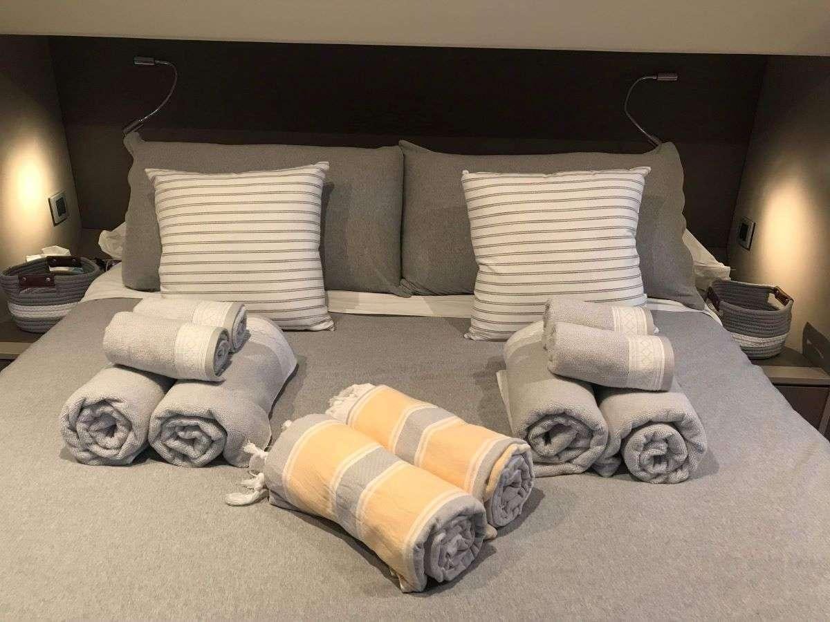 a bed with pillows and pillows aboard SIMONE V Yacht for Charter