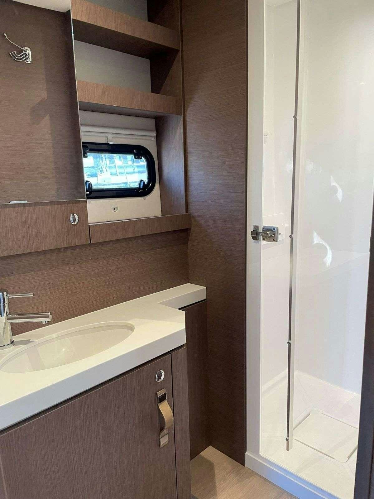 a small bathroom with a tv aboard SIMONE V Yacht for Charter