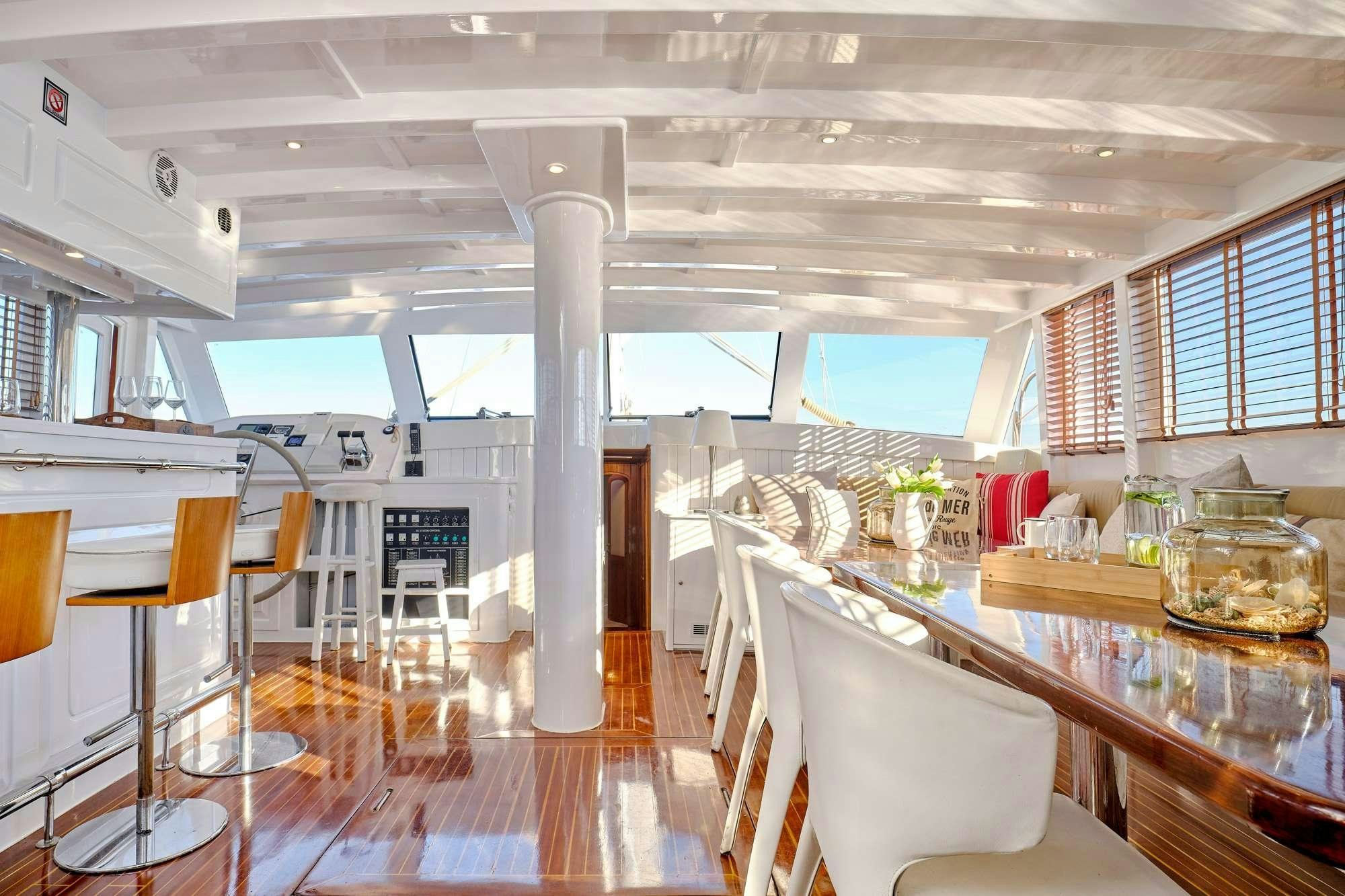a room with tables and chairs aboard WHITE PEARL Yacht for Charter