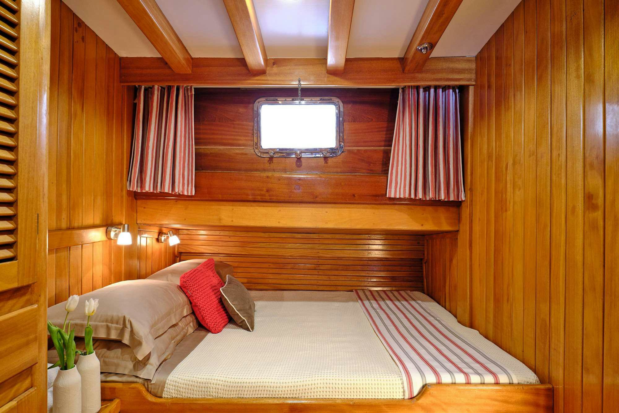 a room with a bed and a window aboard WHITE PEARL Yacht for Charter
