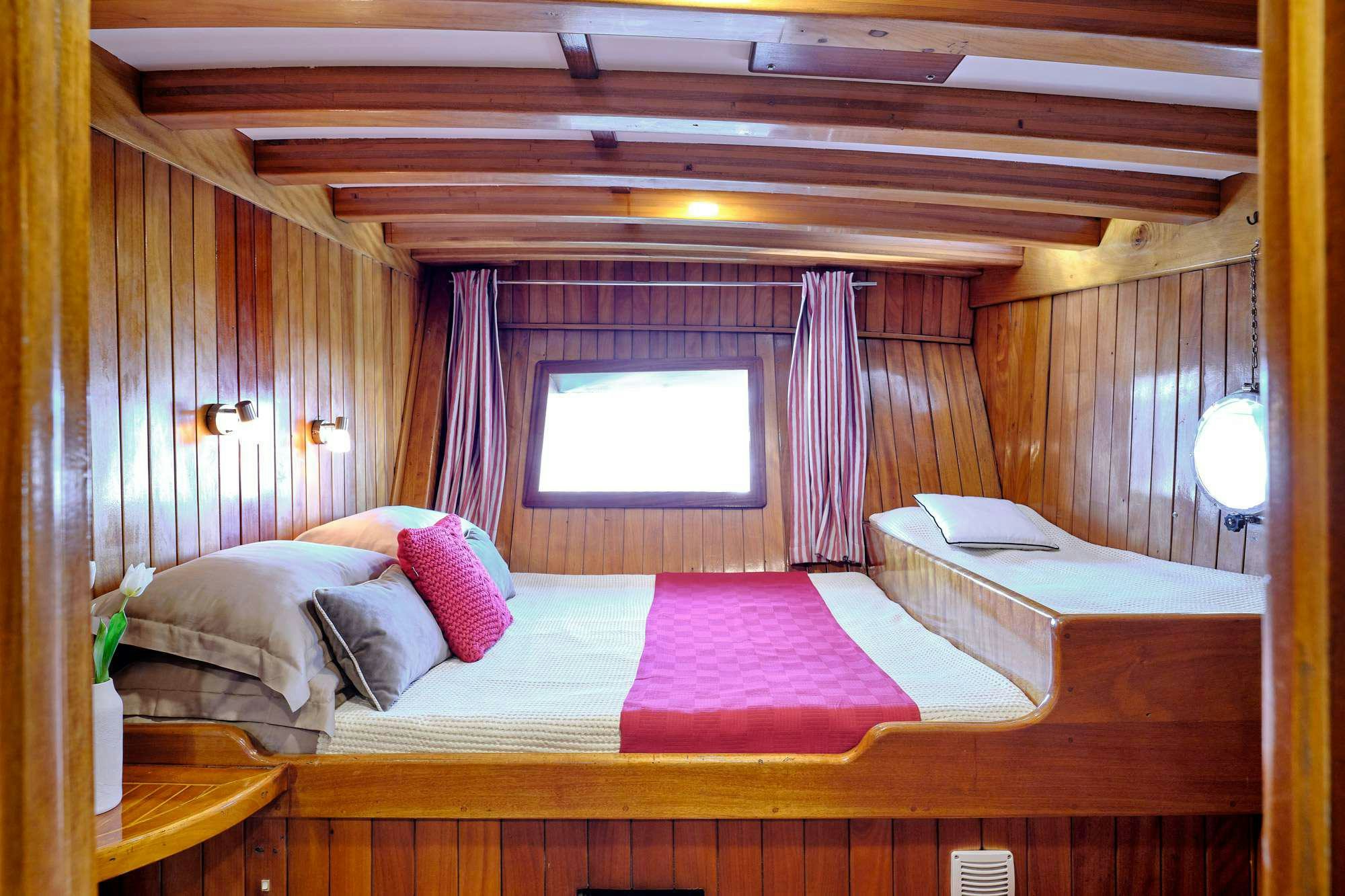 a room with a bed and a window aboard WHITE PEARL Yacht for Charter