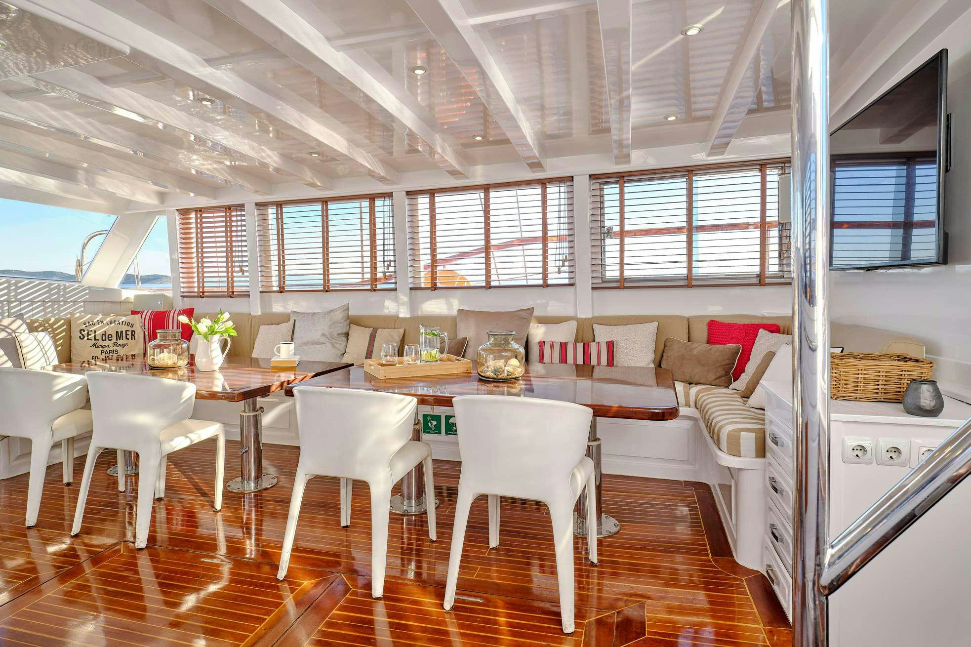 a large room with a table and chairs aboard WHITE PEARL Yacht for Charter