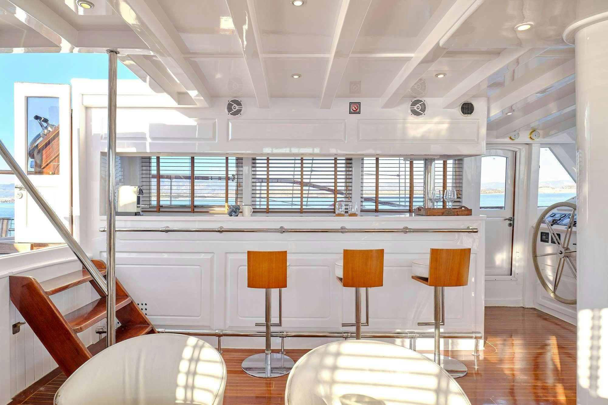 a room with chairs and tables aboard WHITE PEARL Yacht for Charter