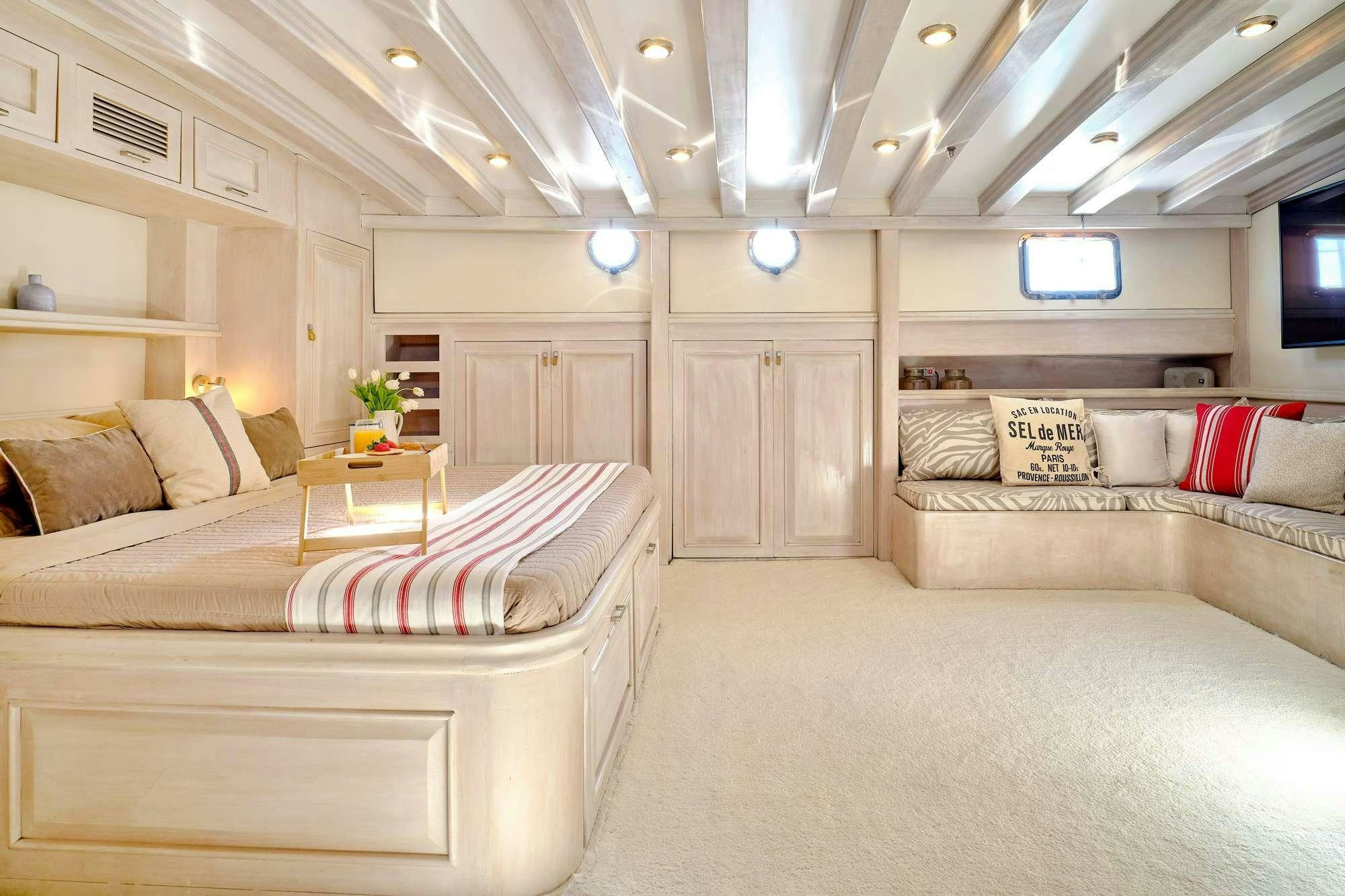 a living room with a couch and a tv aboard WHITE PEARL Yacht for Charter