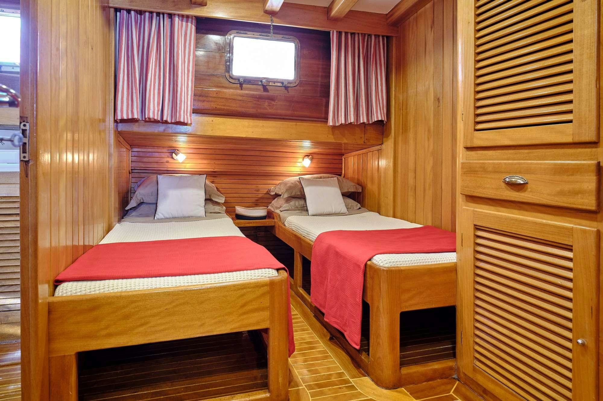 a couple of beds in a room aboard WHITE PEARL Yacht for Charter
