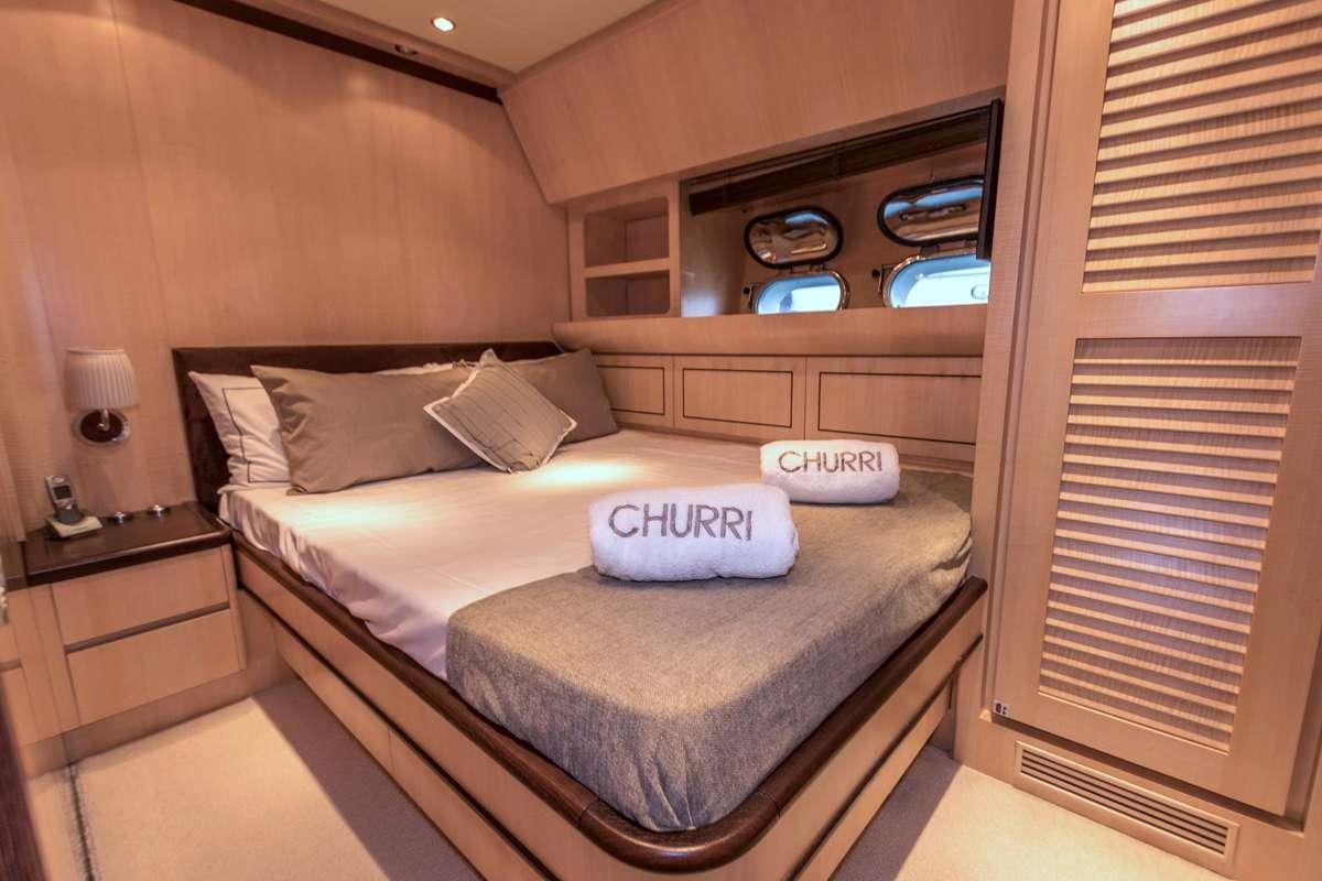 a bed with a white pillow aboard CHURRI Yacht for Charter