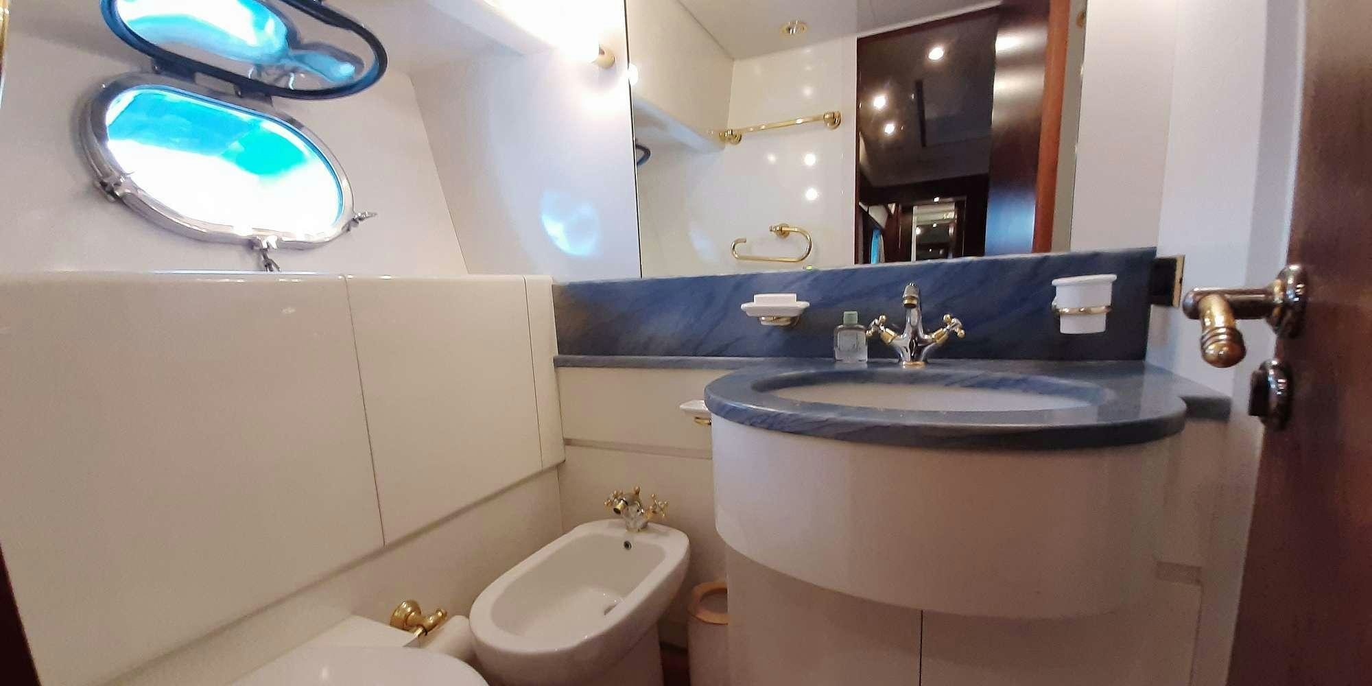 a bathroom with a sink and a mirror aboard OLA Yacht for Charter