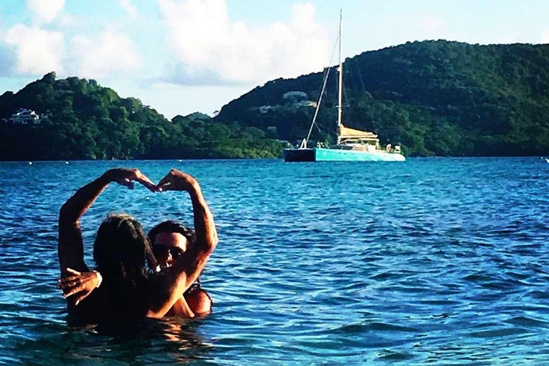 a woman and a man in the water aboard QUEST Yacht for Charter