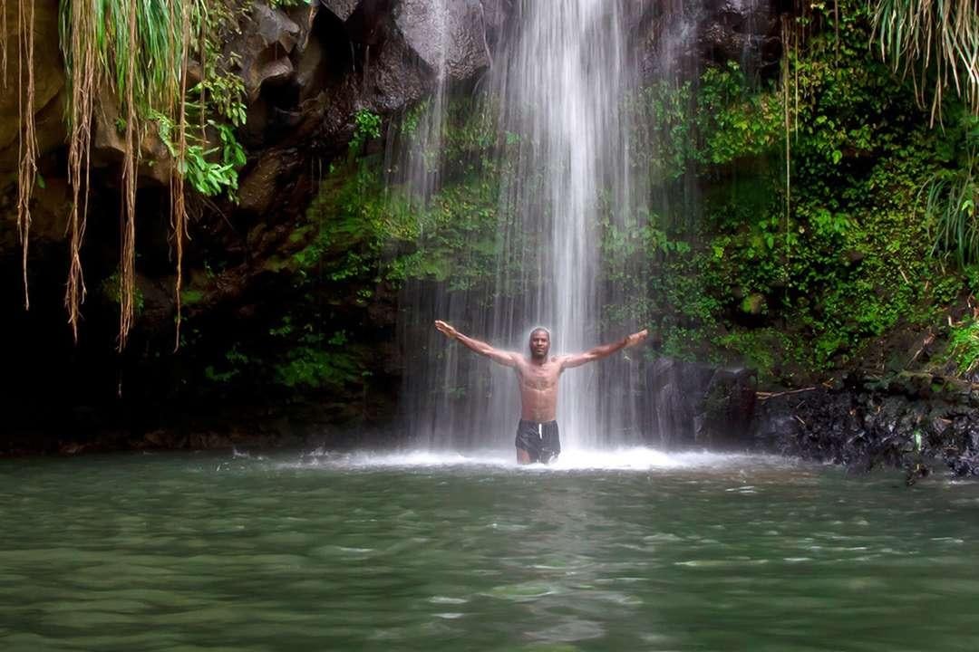 a person standing in a waterfall aboard QUEST Yacht for Charter