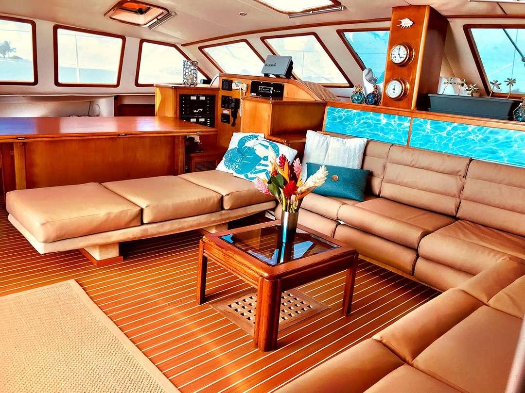 a living room with a couch and a coffee table aboard QUEST Yacht for Charter