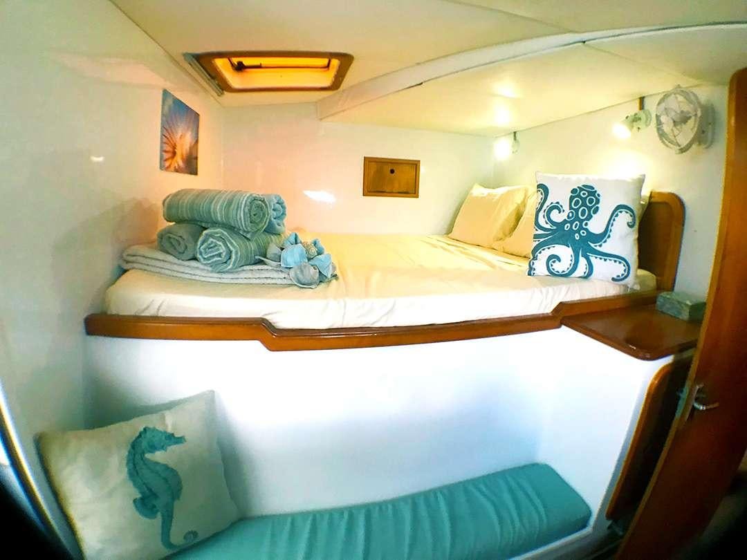 a bed with pillows and pillows aboard QUEST Yacht for Charter
