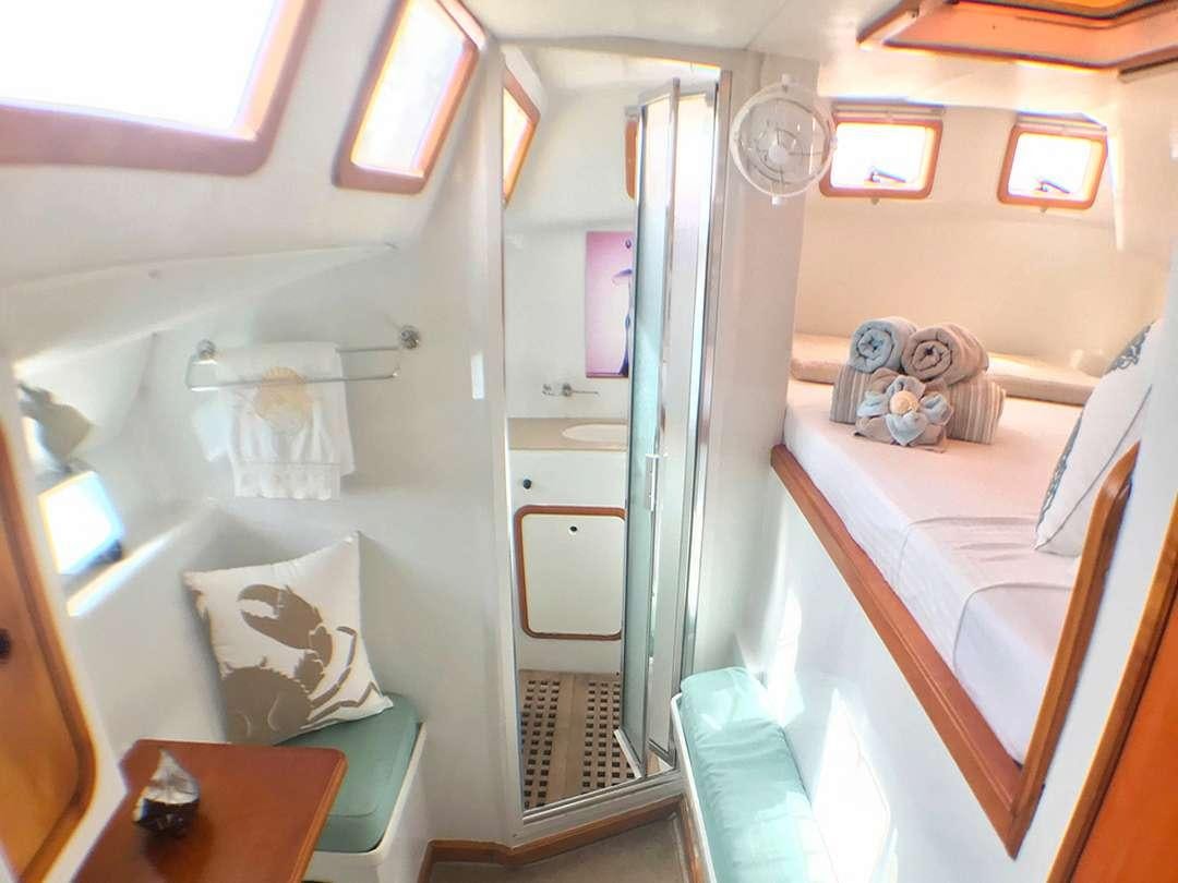 a room with a closet and a bed aboard QUEST Yacht for Charter