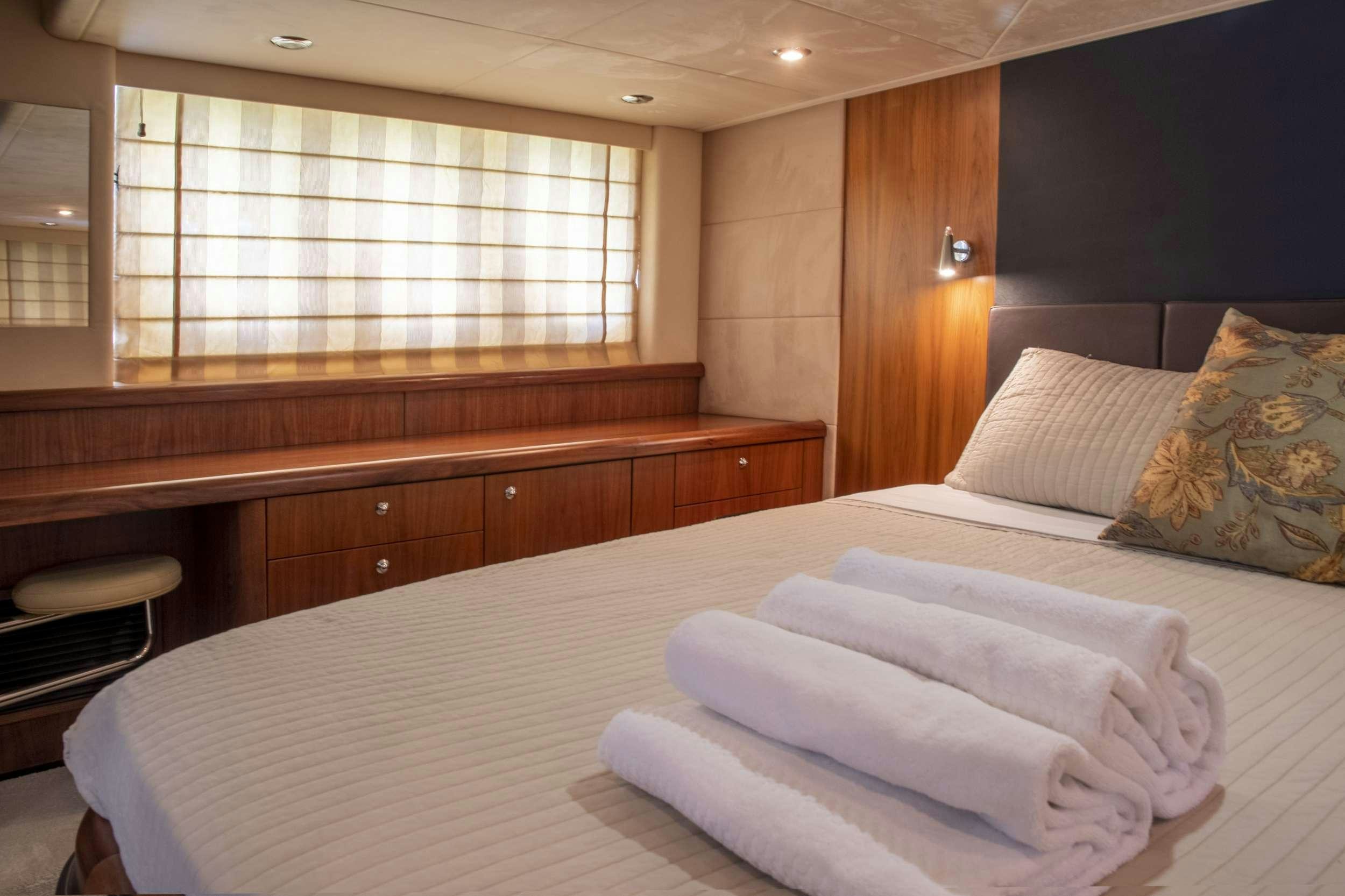 a room with a bed and a window aboard FLIGHT RISK Yacht for Charter