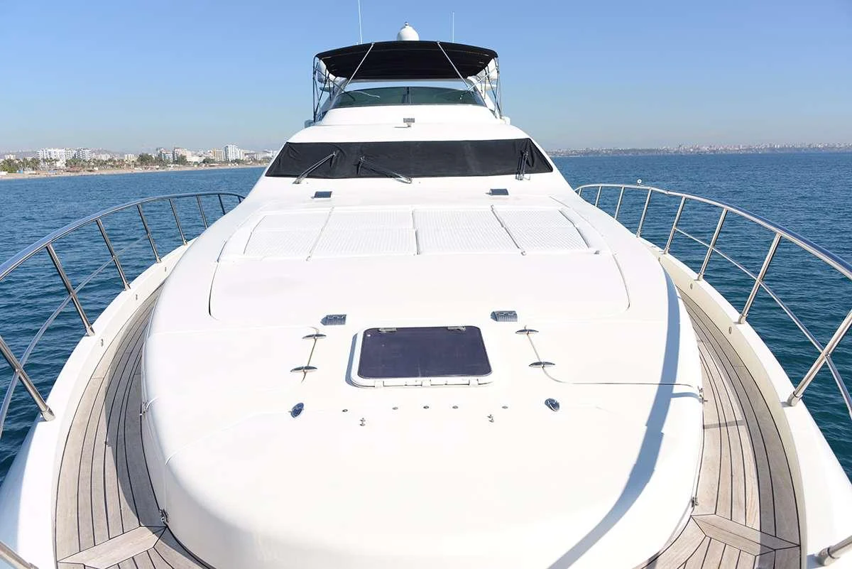 a white yacht on a body of water aboard OBSIDIAN Yacht for Charter