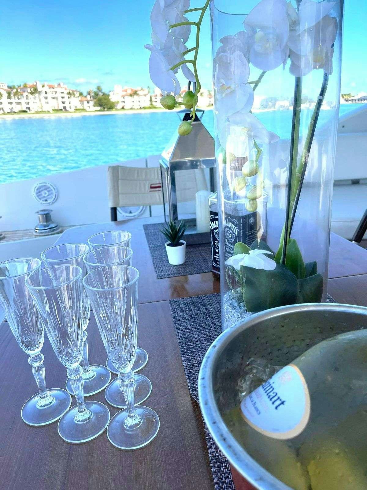 a table with wine glasses aboard LEONARDO Yacht for Charter