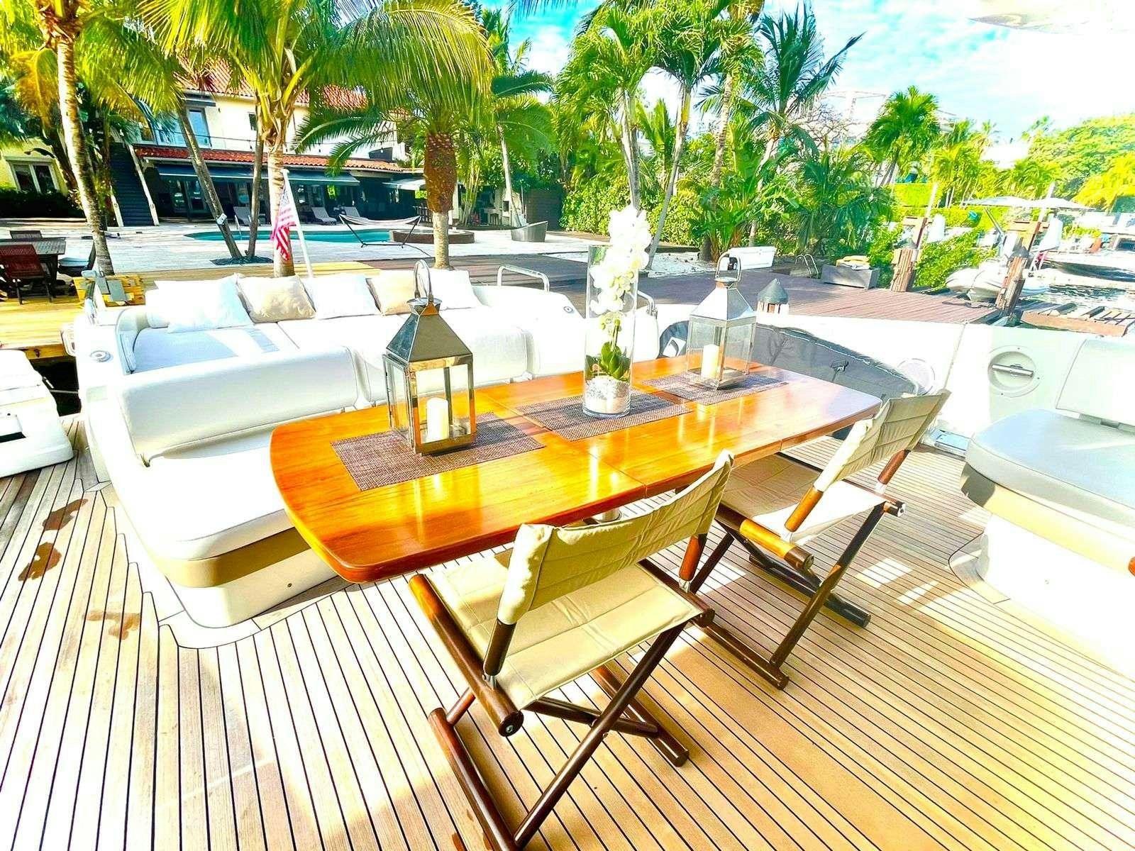 a table with chairs around it aboard LEONARDO Yacht for Charter