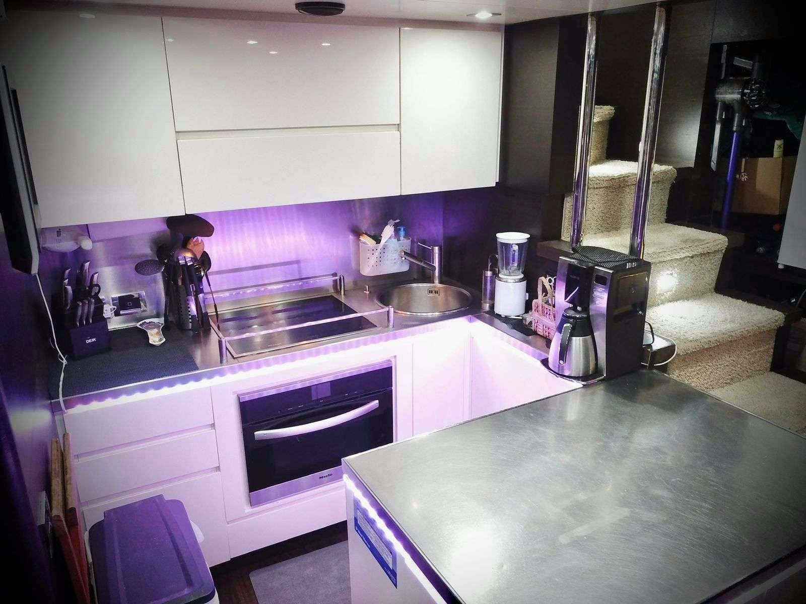 a kitchen with a sink and a stove aboard LEONARDO Yacht for Charter