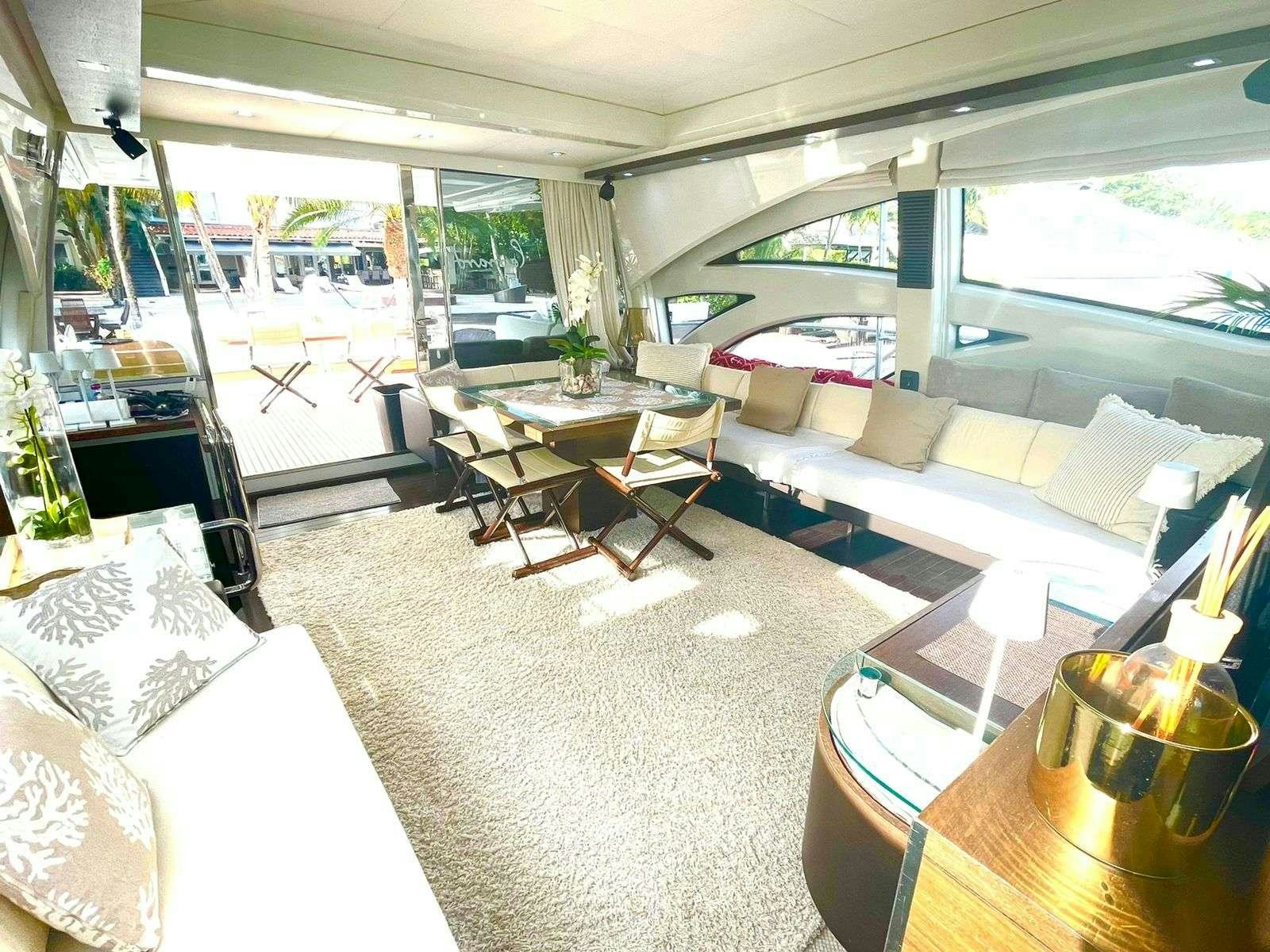 a living room with a large window aboard LEONARDO Yacht for Charter