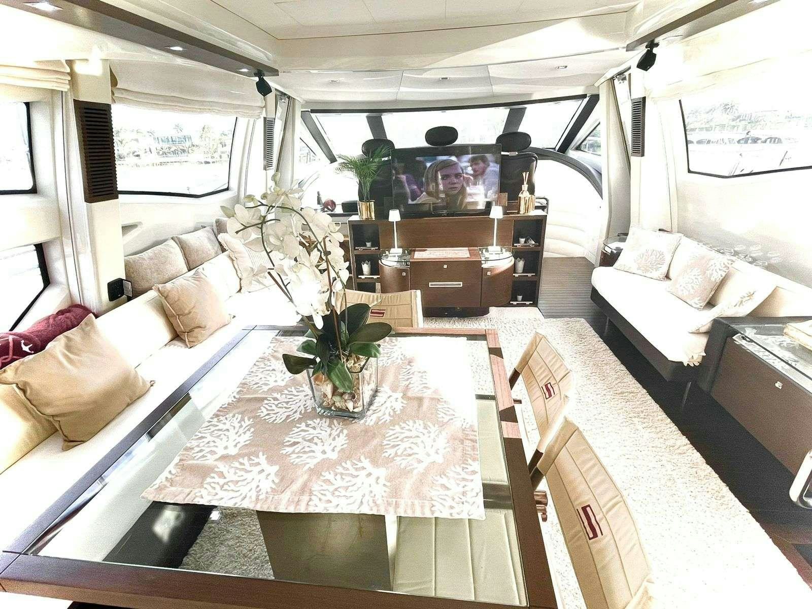 a room with a table and couches aboard LEONARDO Yacht for Charter