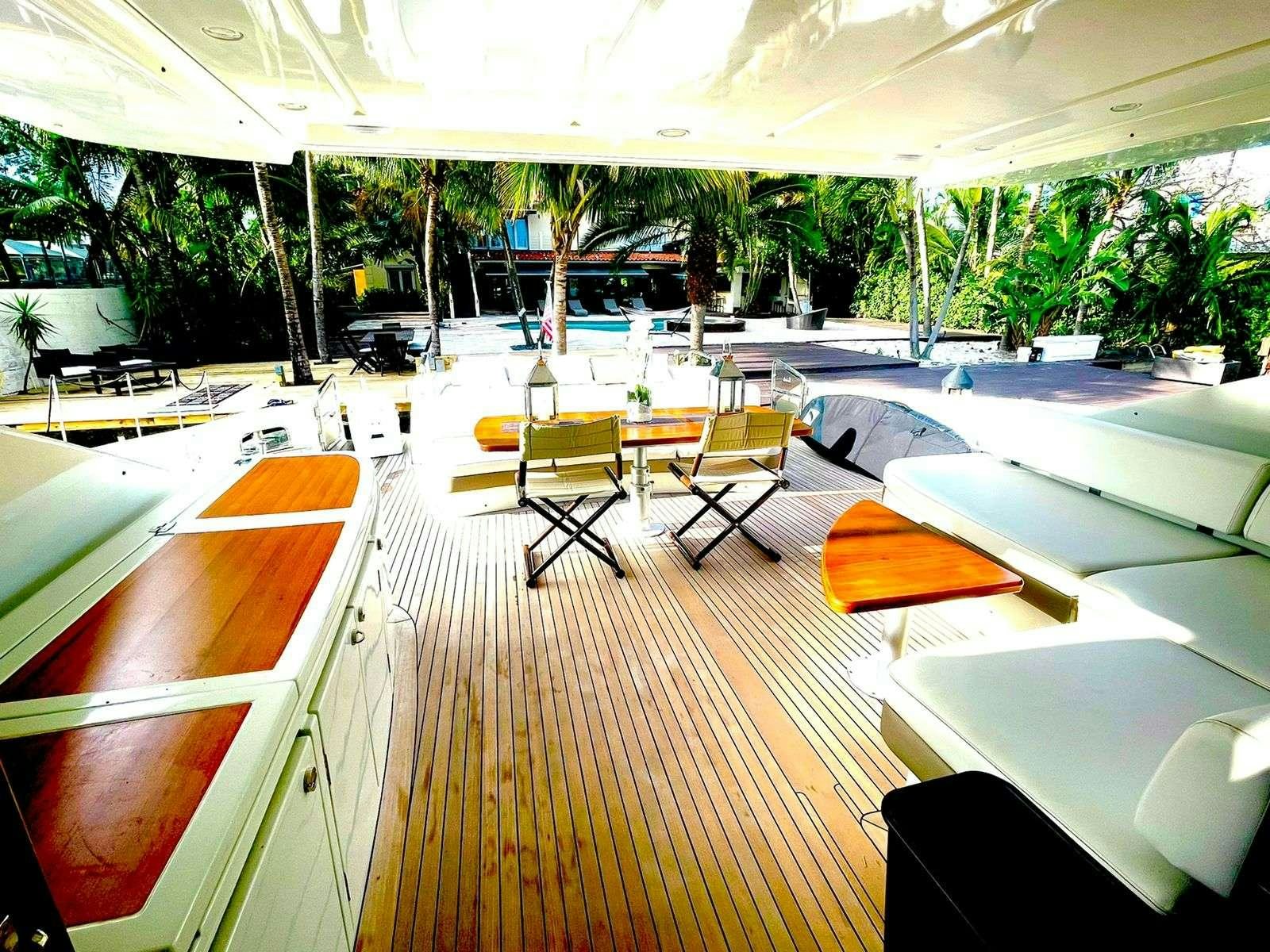 a lounge area with lounge chairs and trees aboard LEONARDO Yacht for Charter