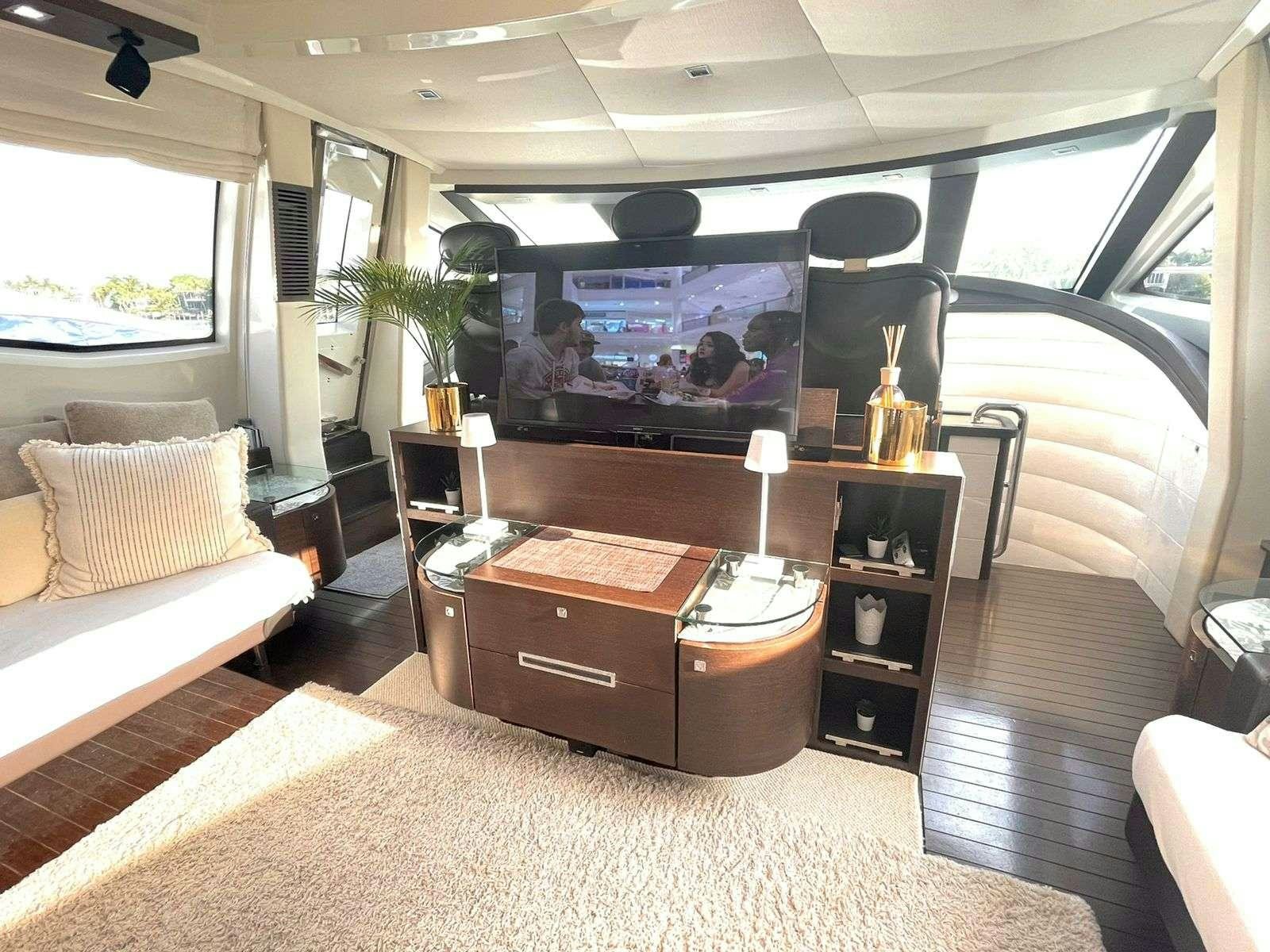 a living room with a large television aboard LEONARDO Yacht for Charter