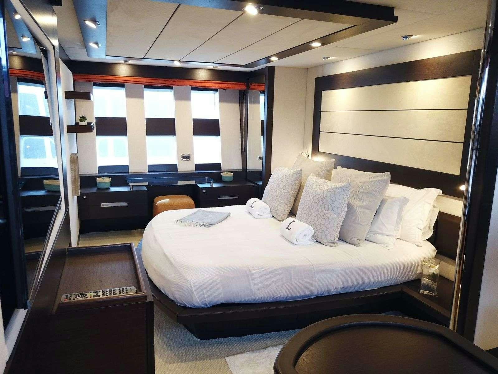 a room with a bed and a window aboard LEONARDO Yacht for Charter