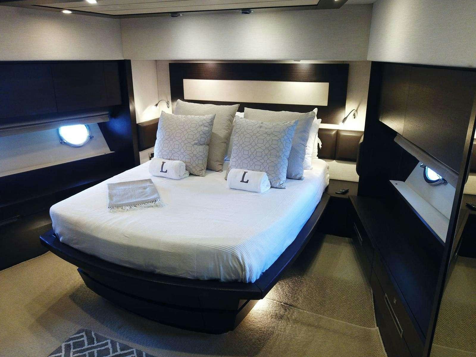 a bed with pillows aboard LEONARDO Yacht for Charter