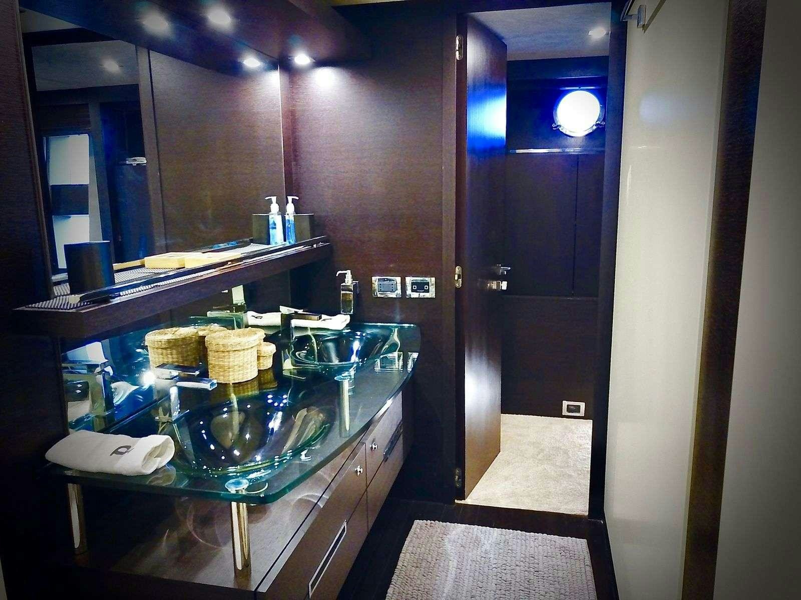 a kitchen with a countertop sink and a mirror aboard LEONARDO Yacht for Charter