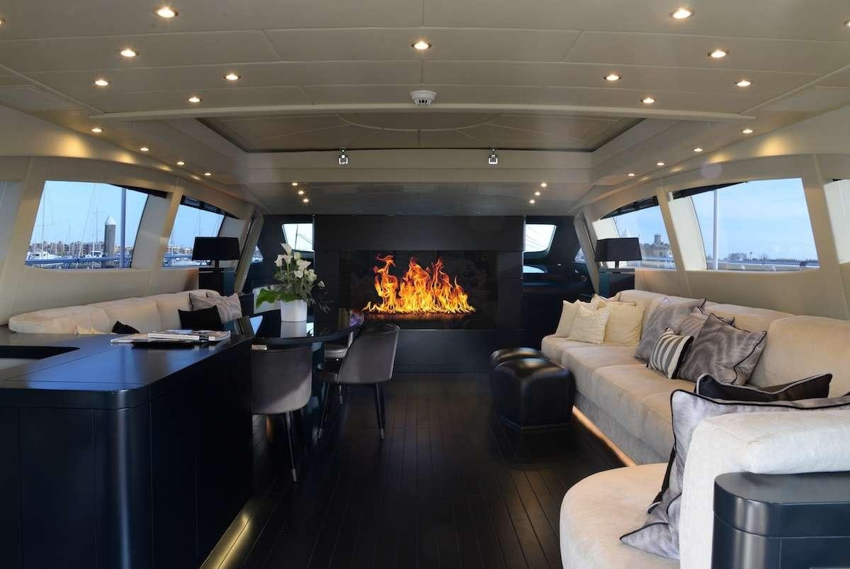 a living room with a fireplace aboard ONLY ONE Yacht for Charter
