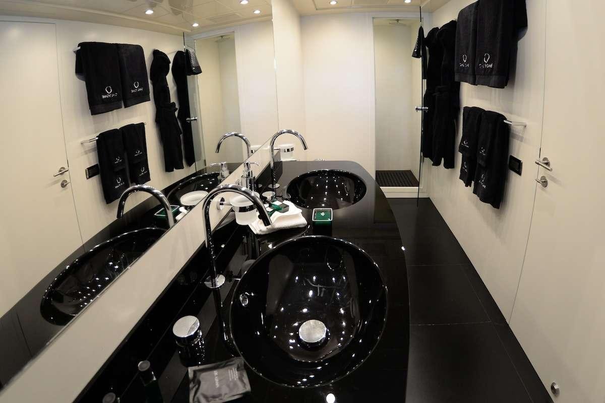 a group of black sinks in a bathroom aboard ONLY ONE Yacht for Charter