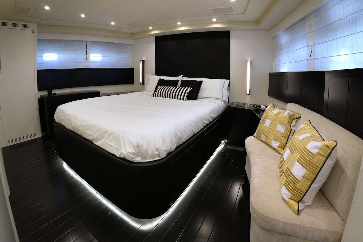 a room with a bed and a couch aboard ONLY ONE Yacht for Charter