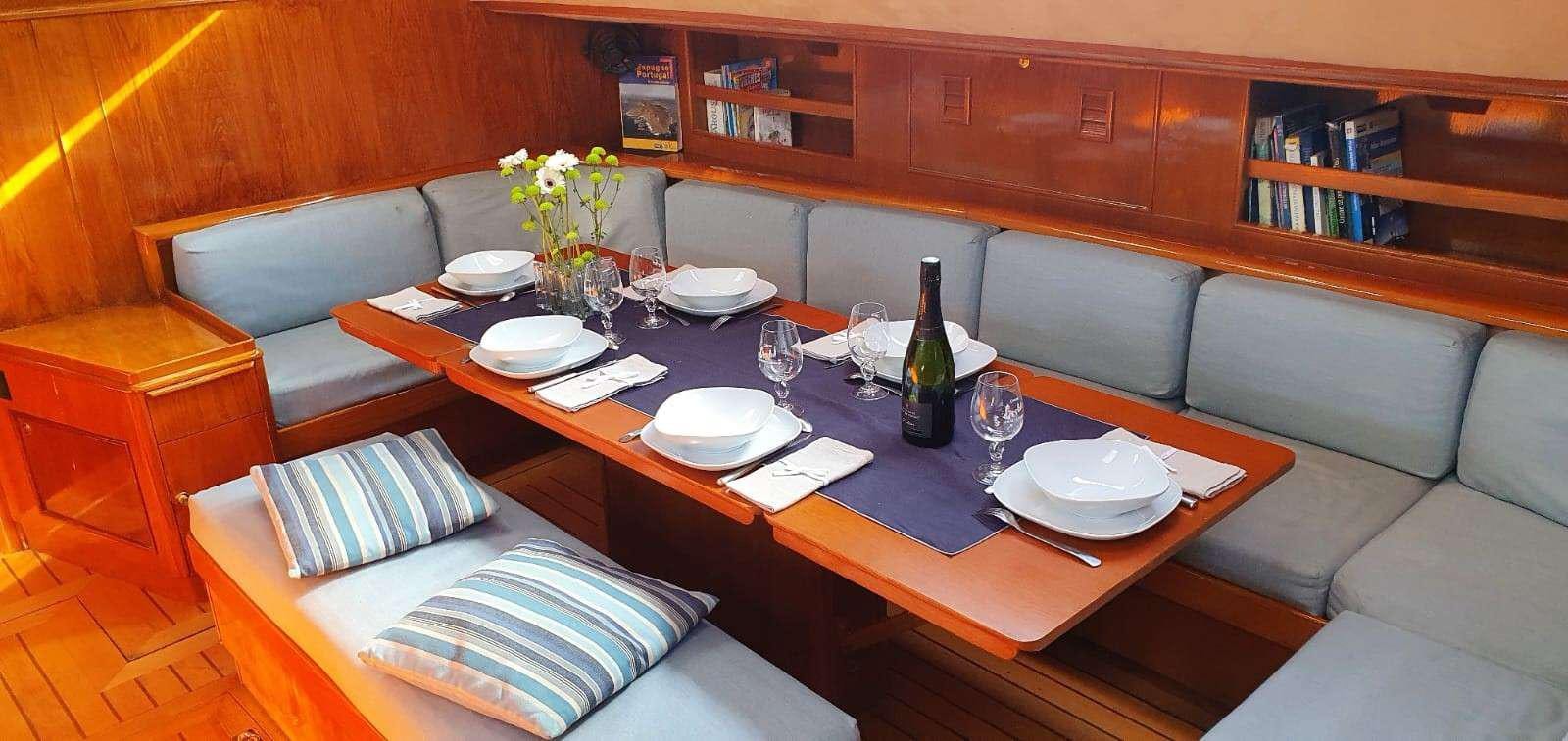 a table with plates and glasses on it aboard TANANA Yacht for Charter