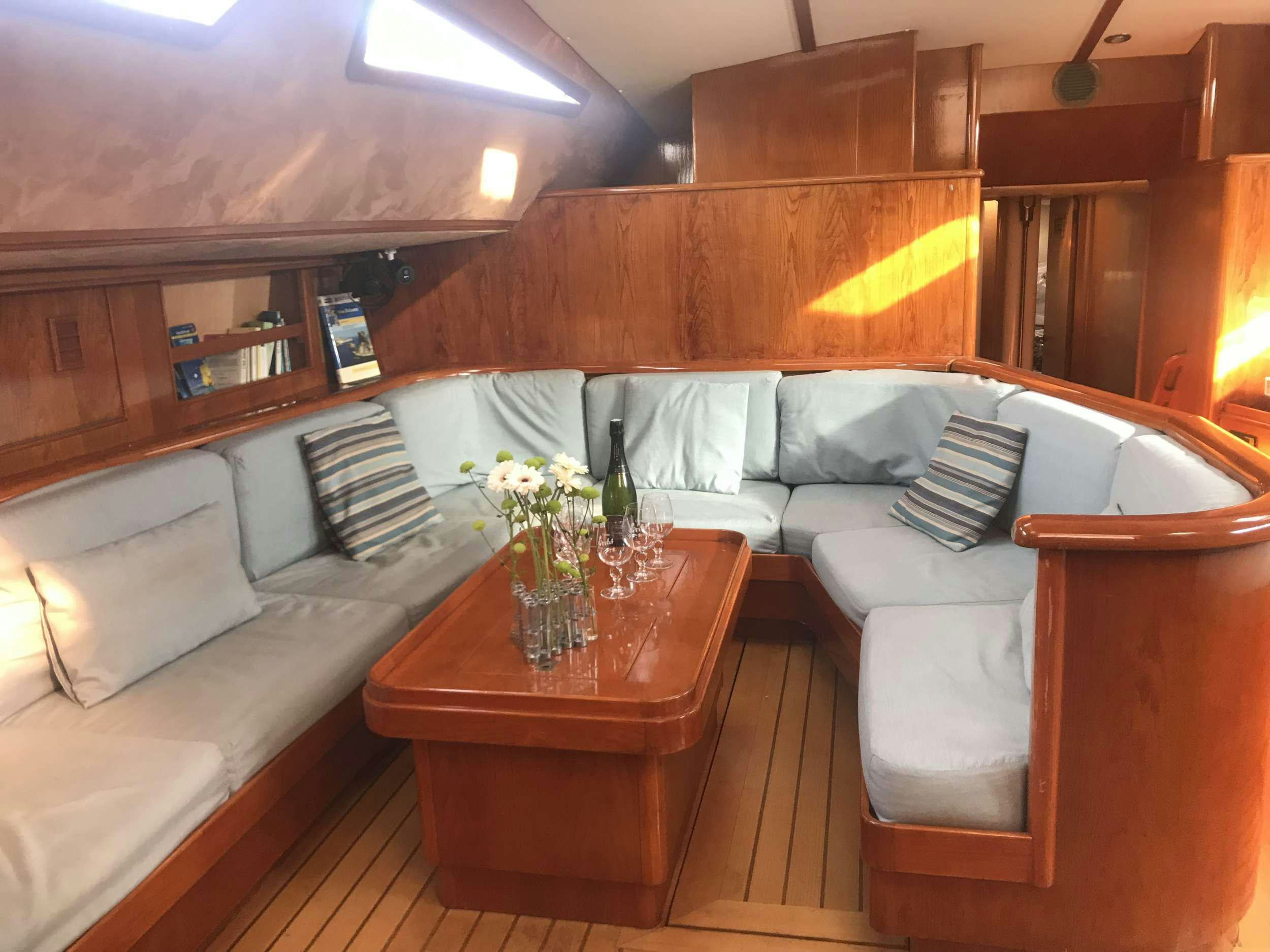 a living room with a couch and a coffee table aboard TANANA Yacht for Charter