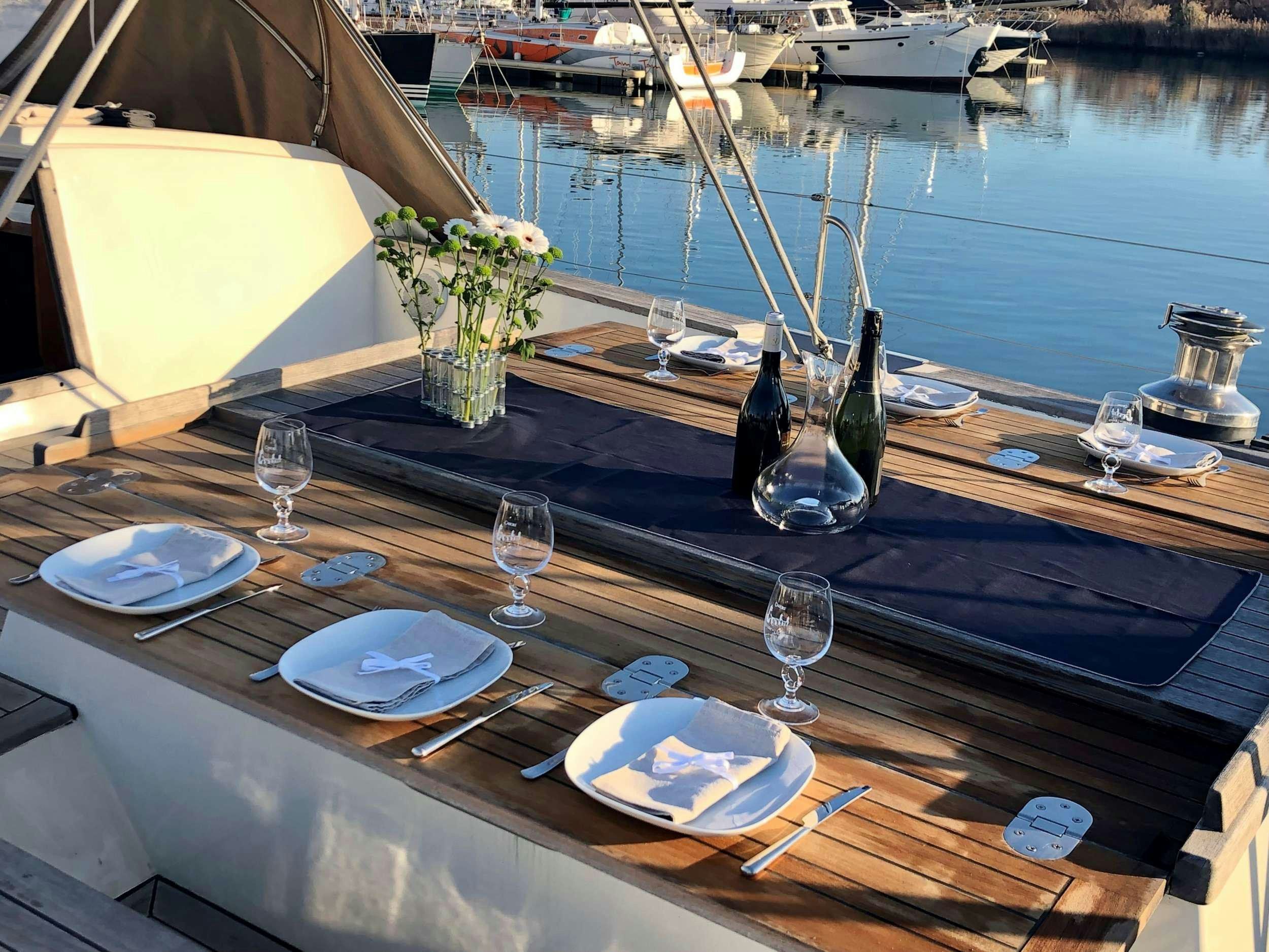 a table with plates and glasses on it aboard TANANA Yacht for Charter