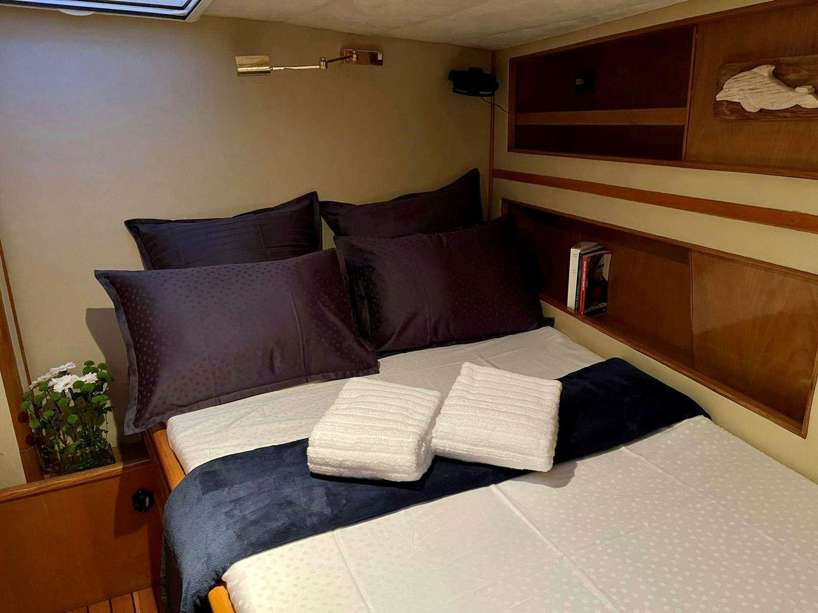a bed with pillows and pillows aboard TANANA Yacht for Charter
