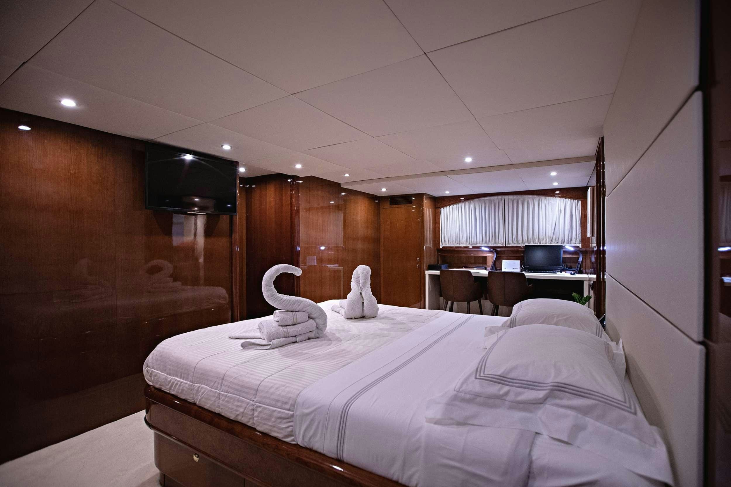 a bed with a white sheet aboard THEION Yacht for Charter
