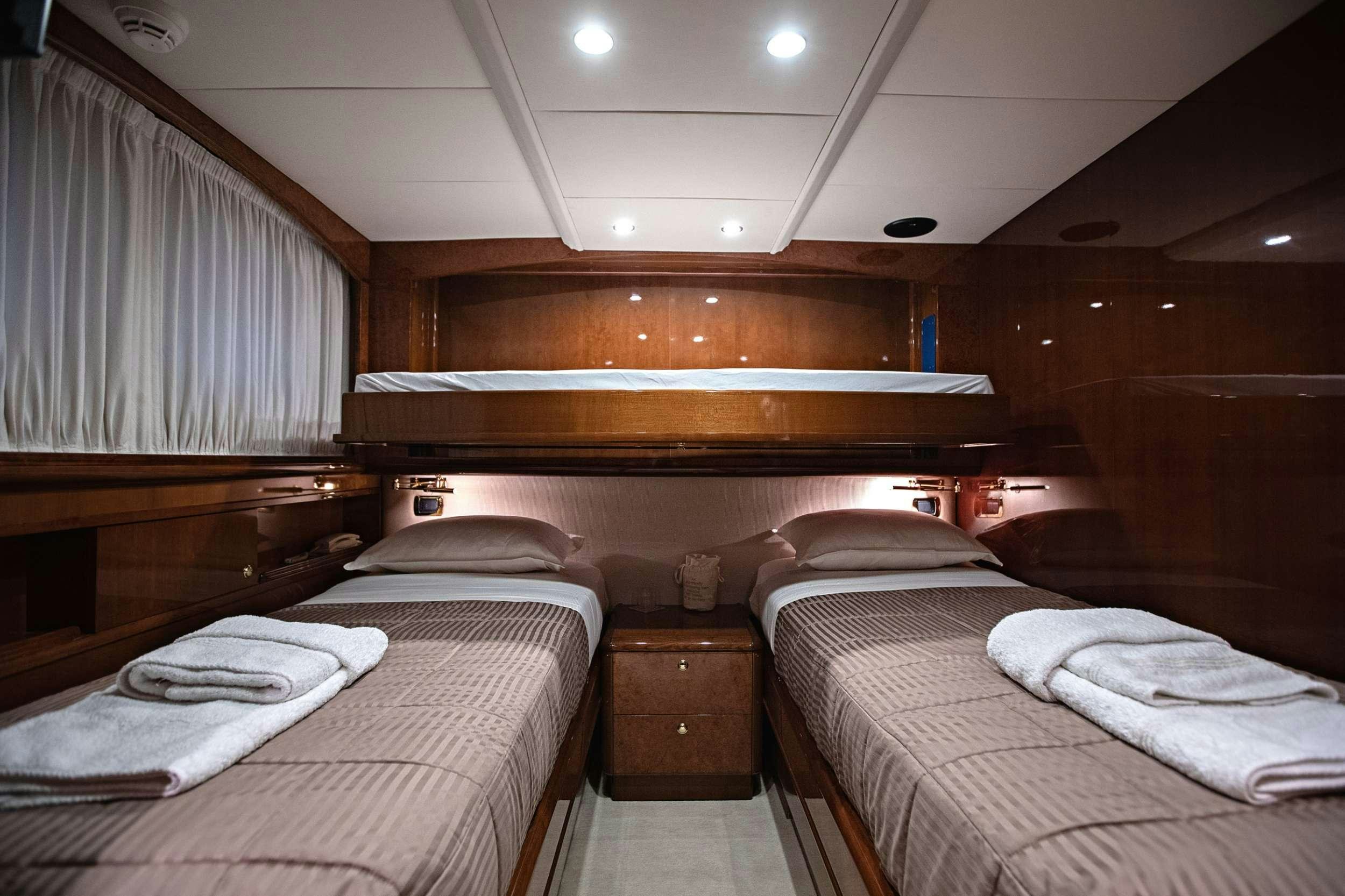a room with bunk beds aboard THEION Yacht for Charter