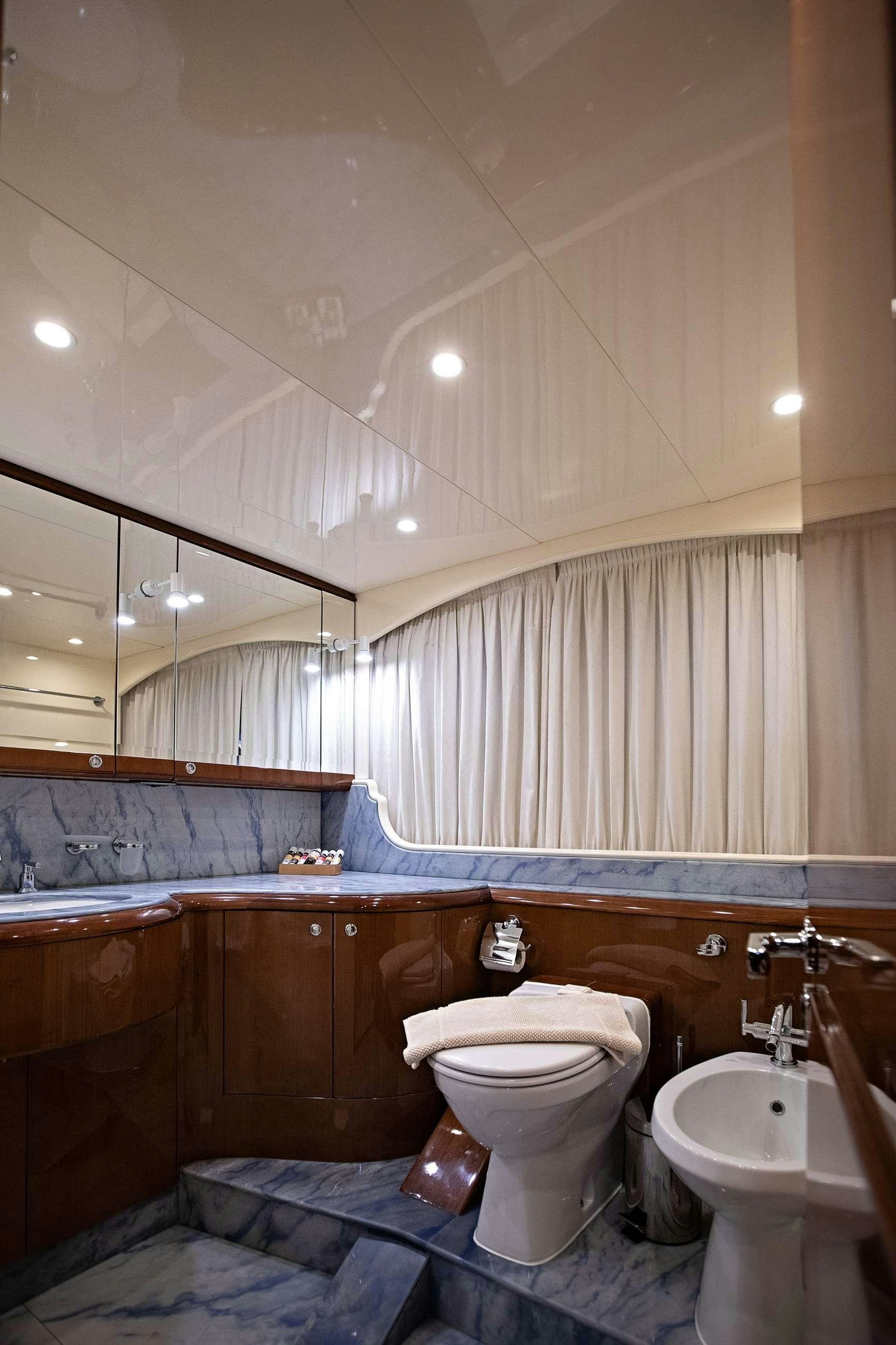 a bathroom with a toilet and sink aboard THEION Yacht for Charter