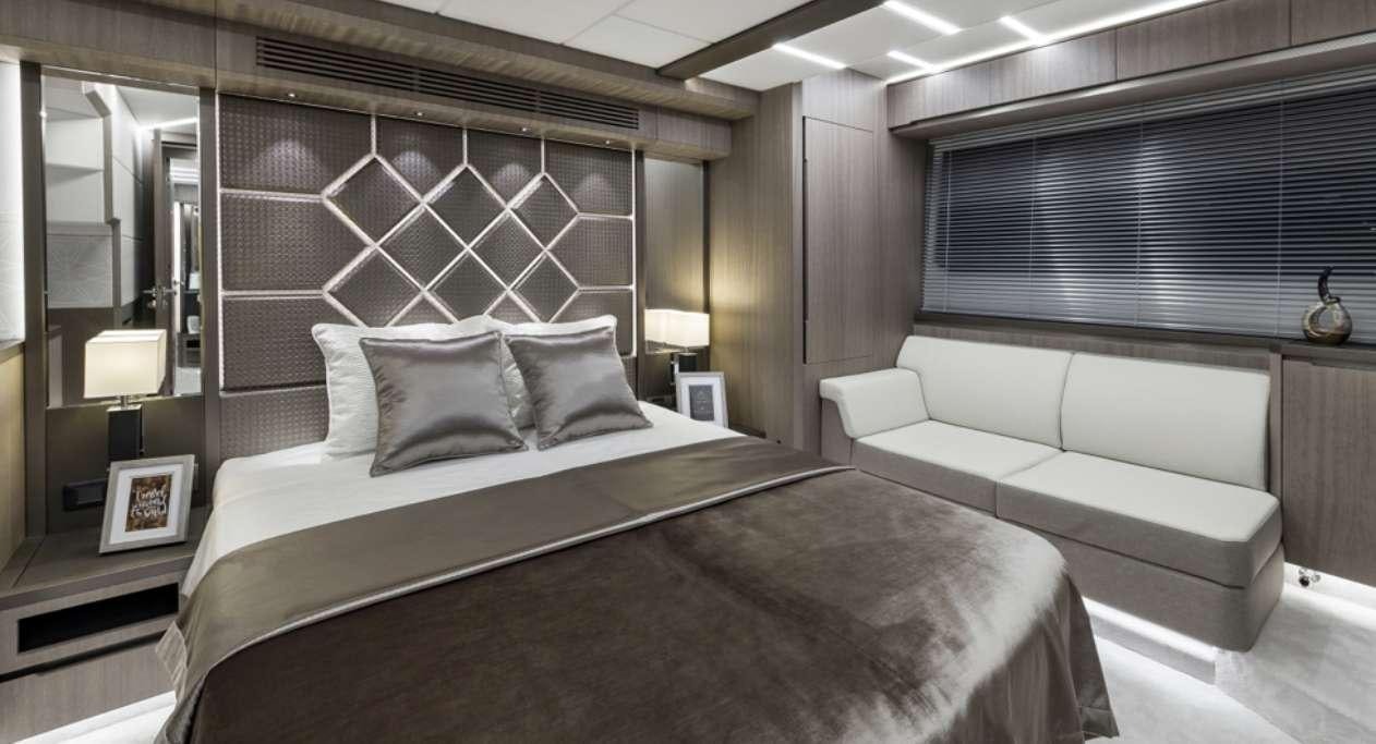 a room with a bed and a couch aboard TRIPLE T Yacht for Charter