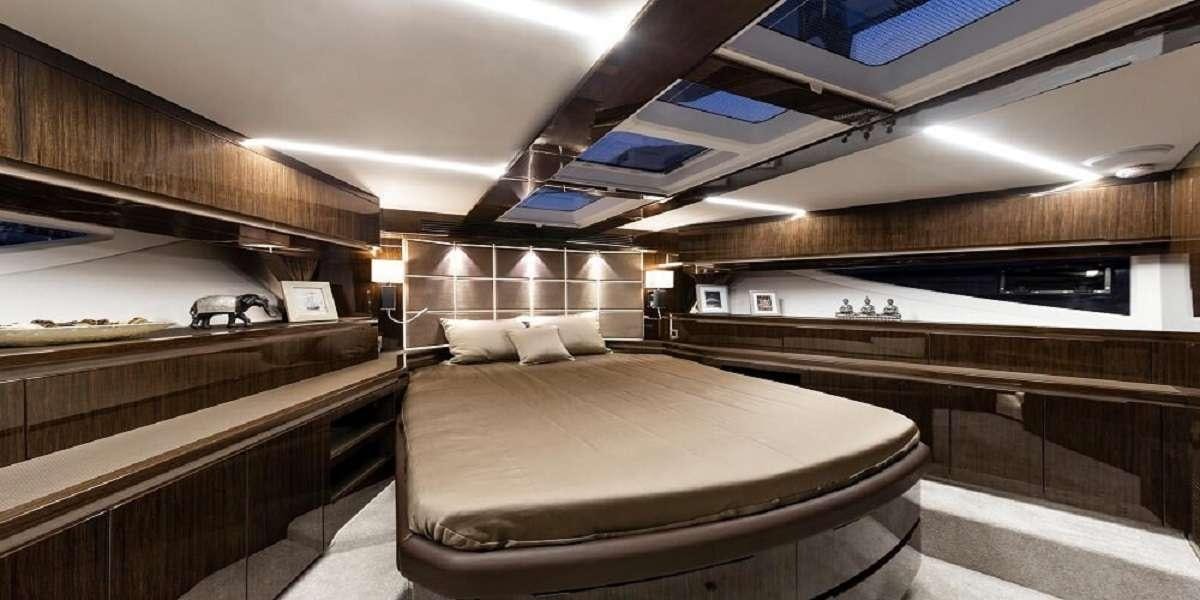 a room with a bed and a desk aboard TRIPLE T Yacht for Charter