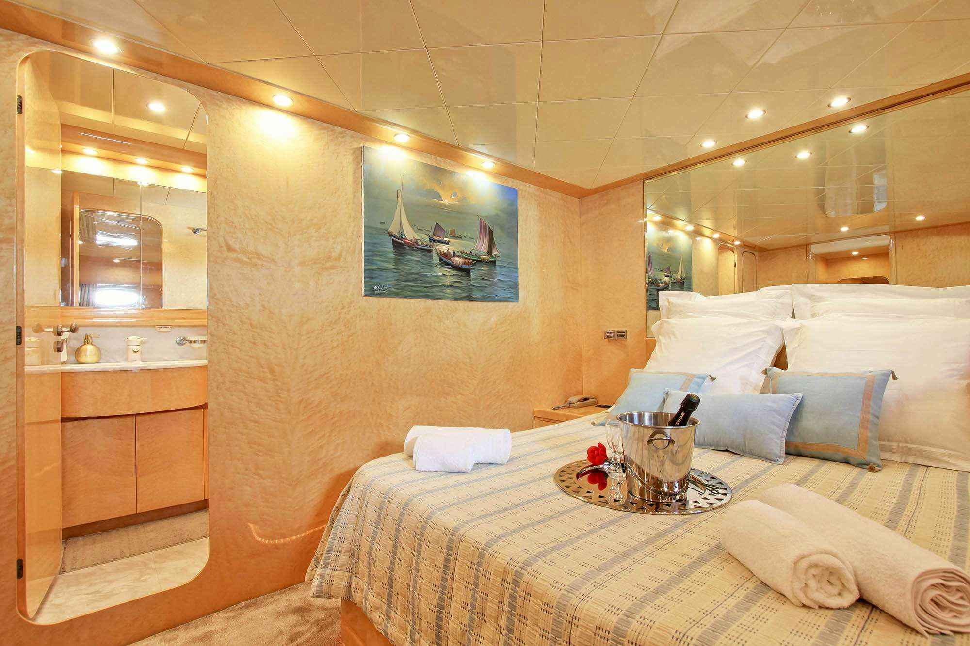 a room with a bed and a mirror aboard PRIME Yacht for Charter
