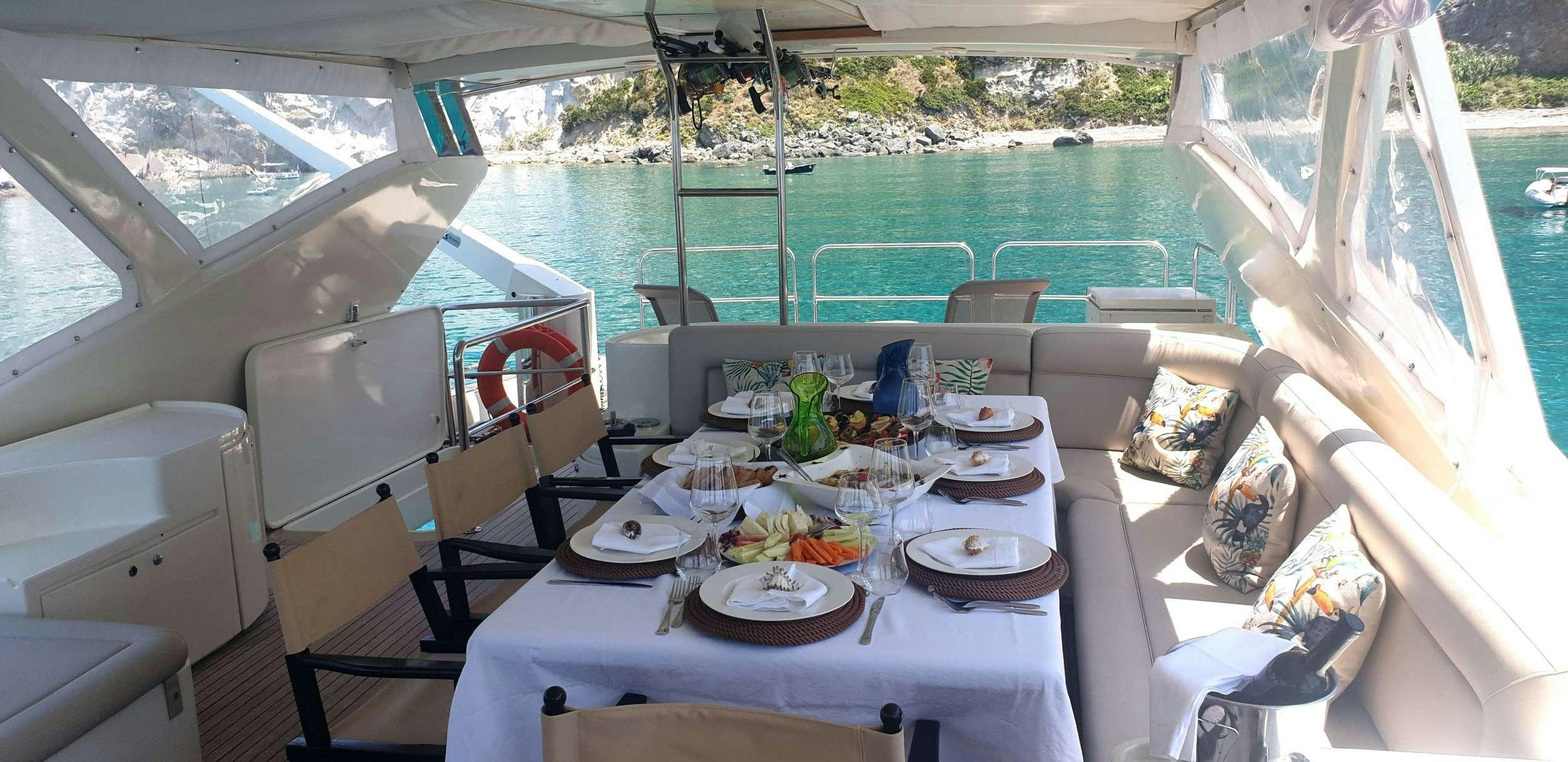 a table with plates and food on it aboard PRIME Yacht for Charter