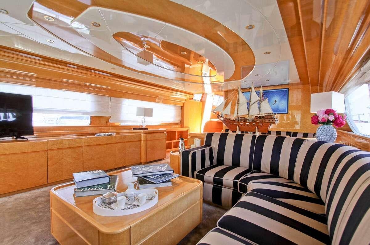 a room with a couch and a coffee table aboard PRIME Yacht for Charter