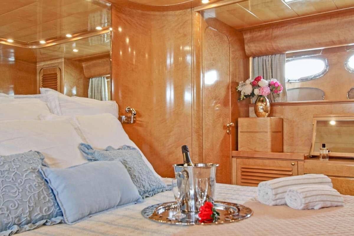 a bed with a tray of food aboard PRIME Yacht for Charter